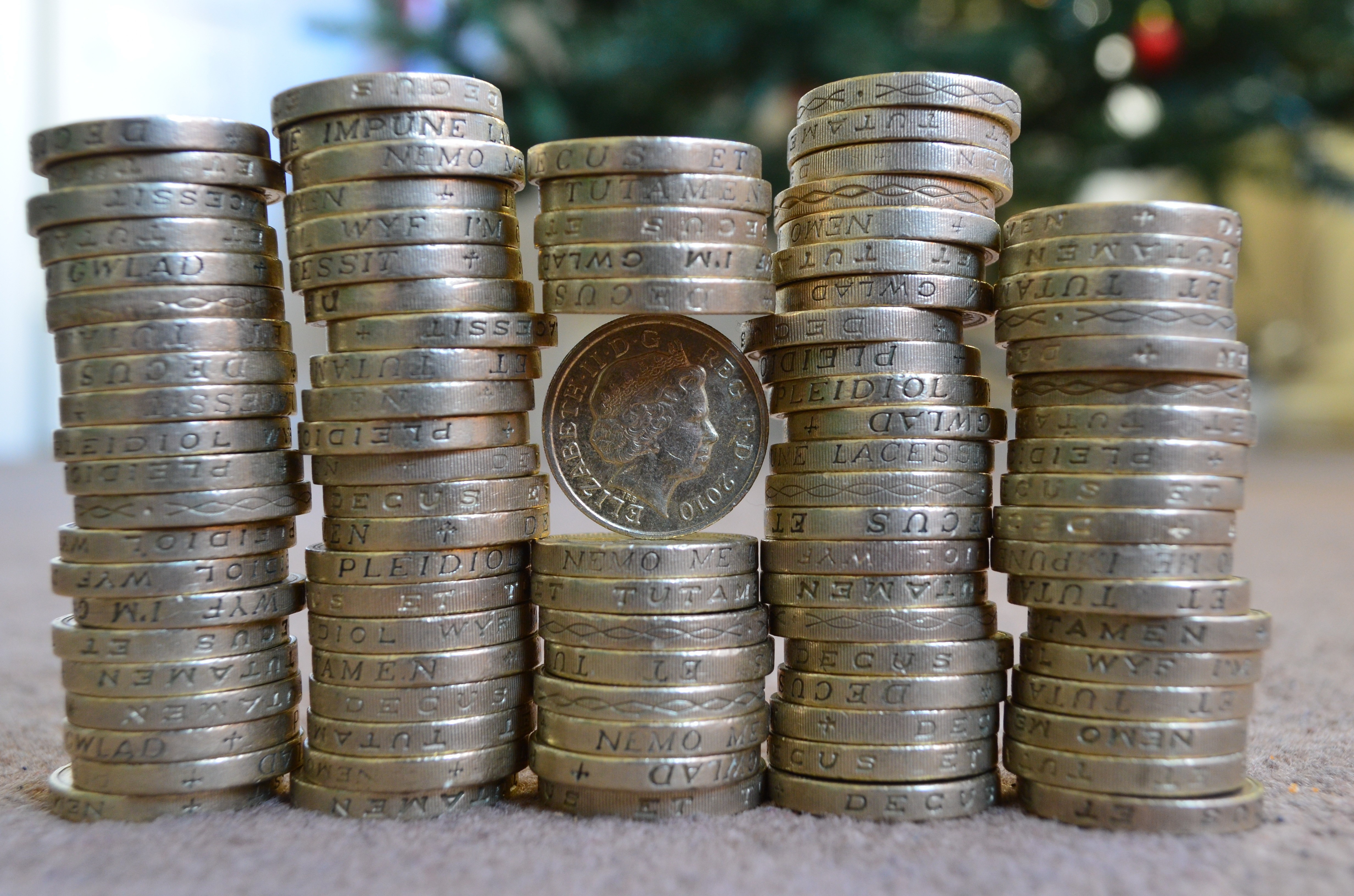 Stacks of British Pounds coins with Queen Elizabeth II HD Wallpaper
