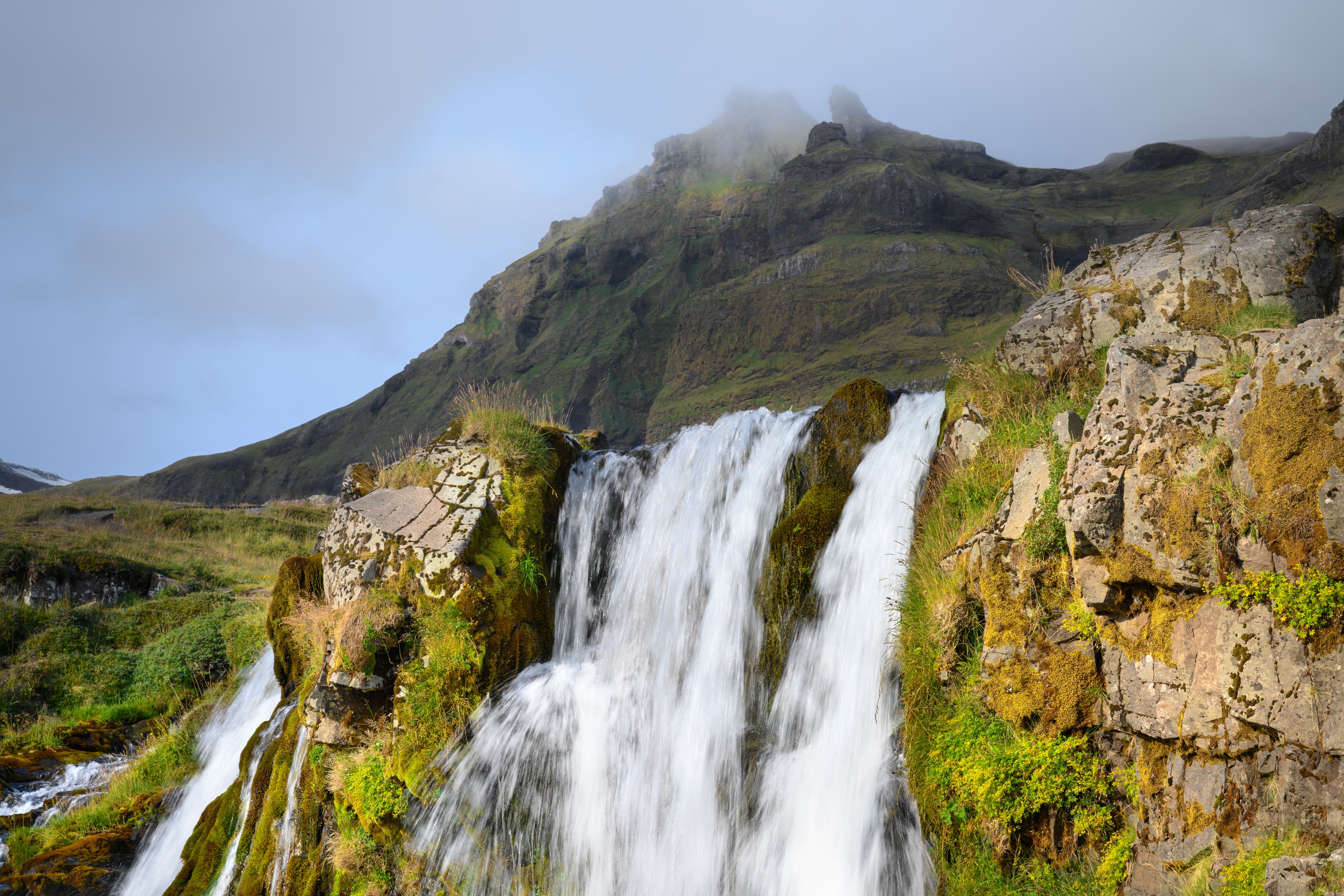 Waterfall cascading down mossy rocks in Iceland HD Wallpaper