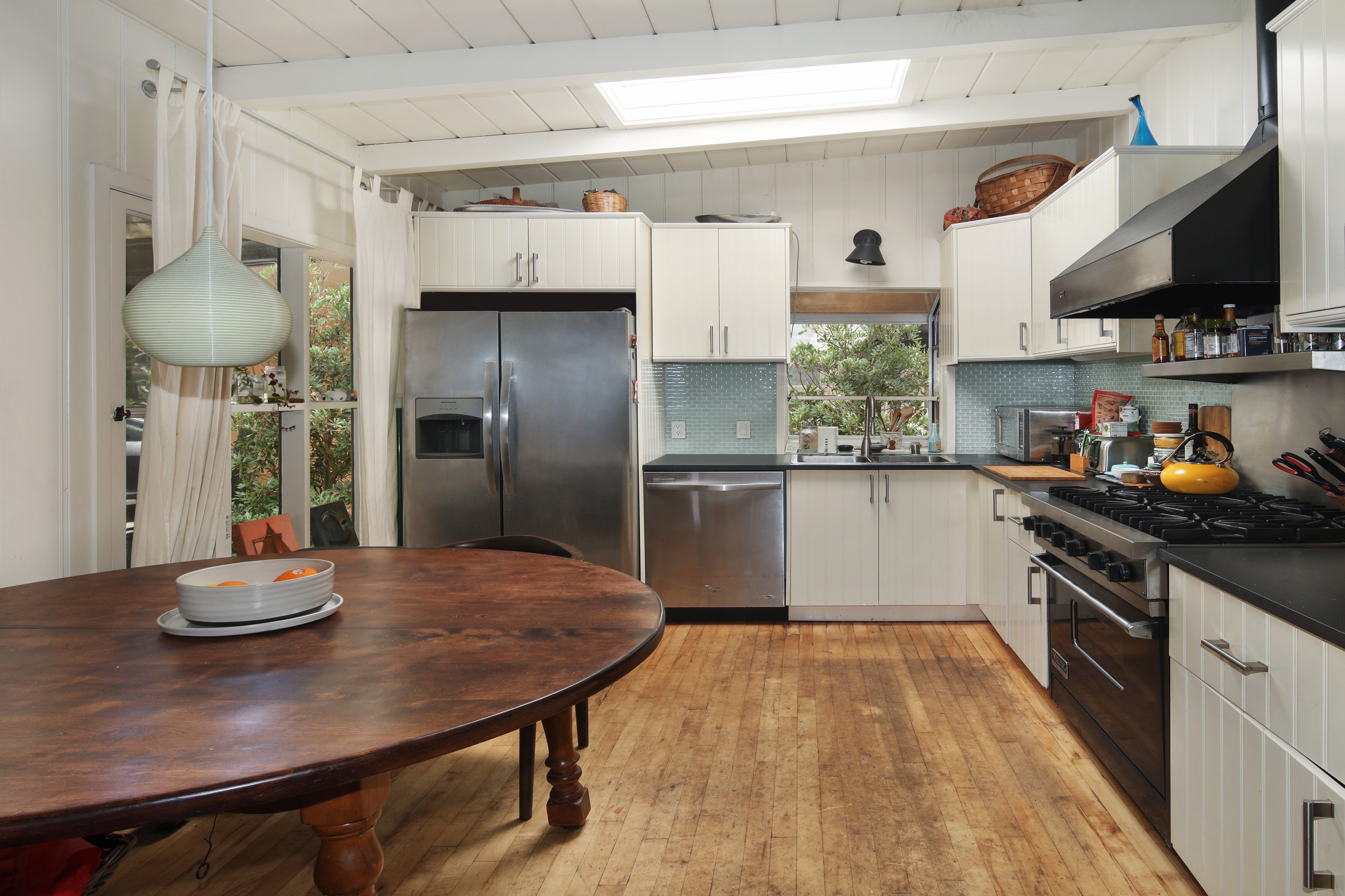 Kitchen with dining table and appliances HD Wallpaper