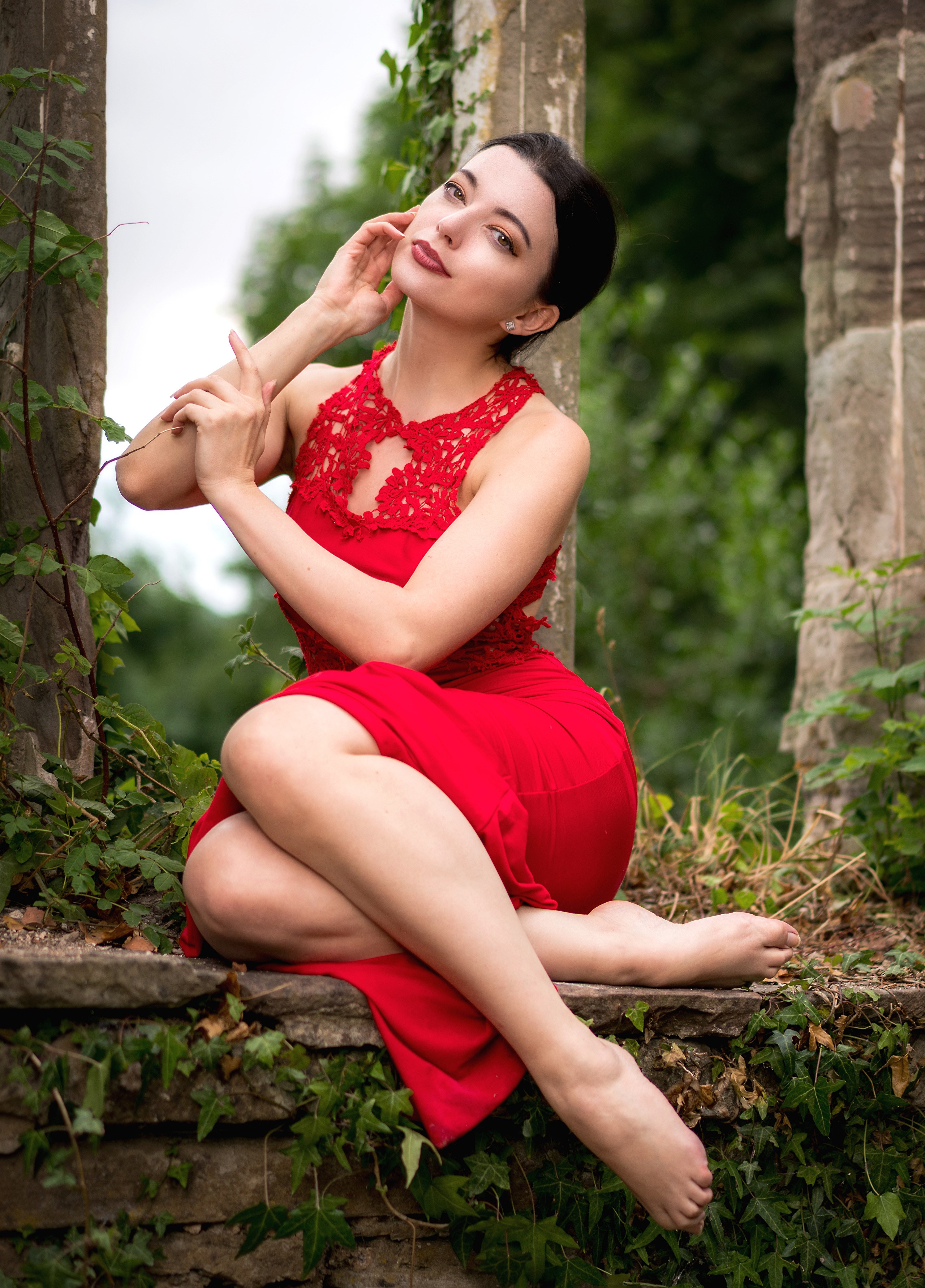 Brunette woman in red dress sitting by ruins HD Phone Wallpaper