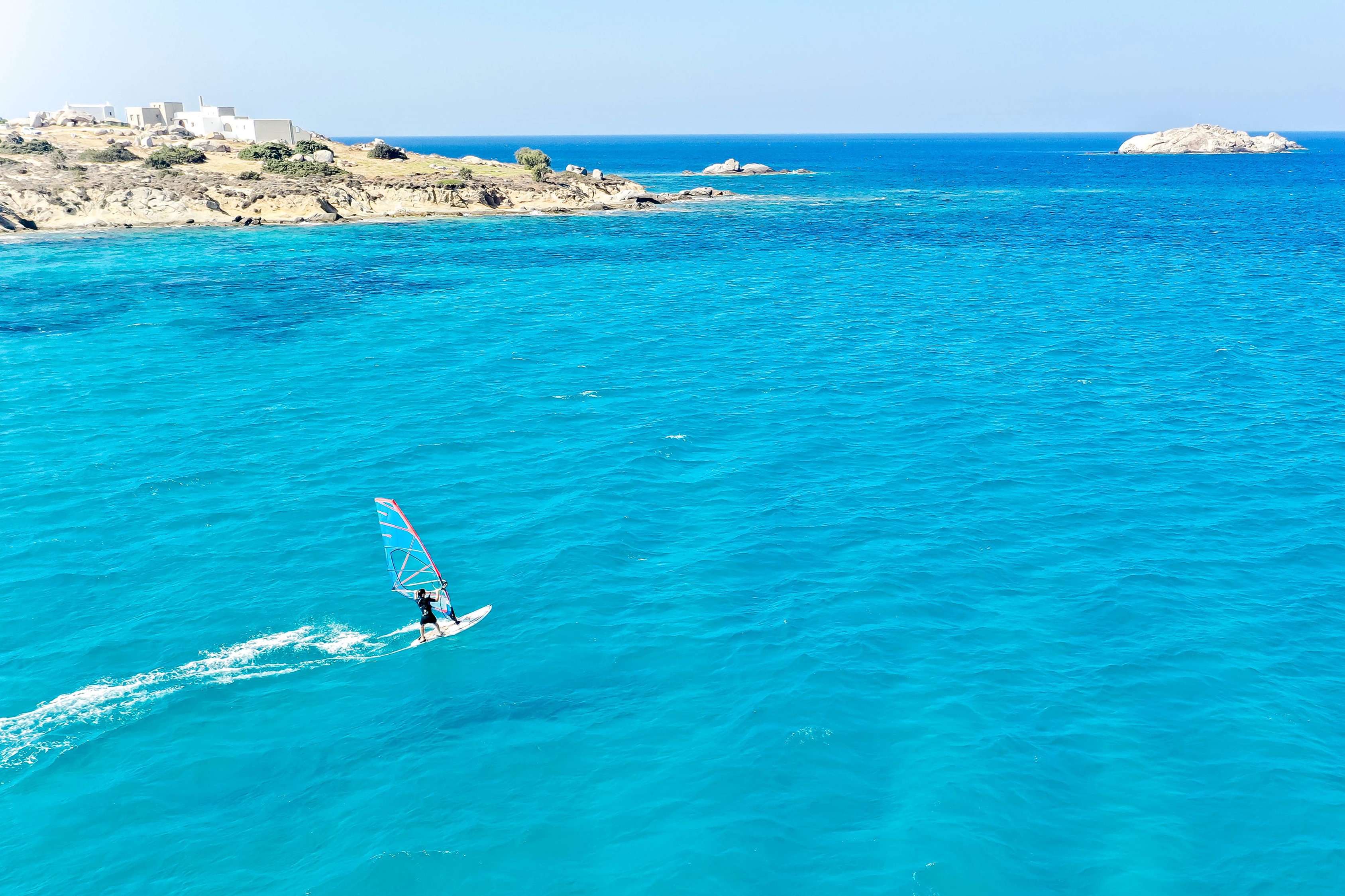 Windsurfer on turquoise water near Naxos City, Greece HD Wallpaper