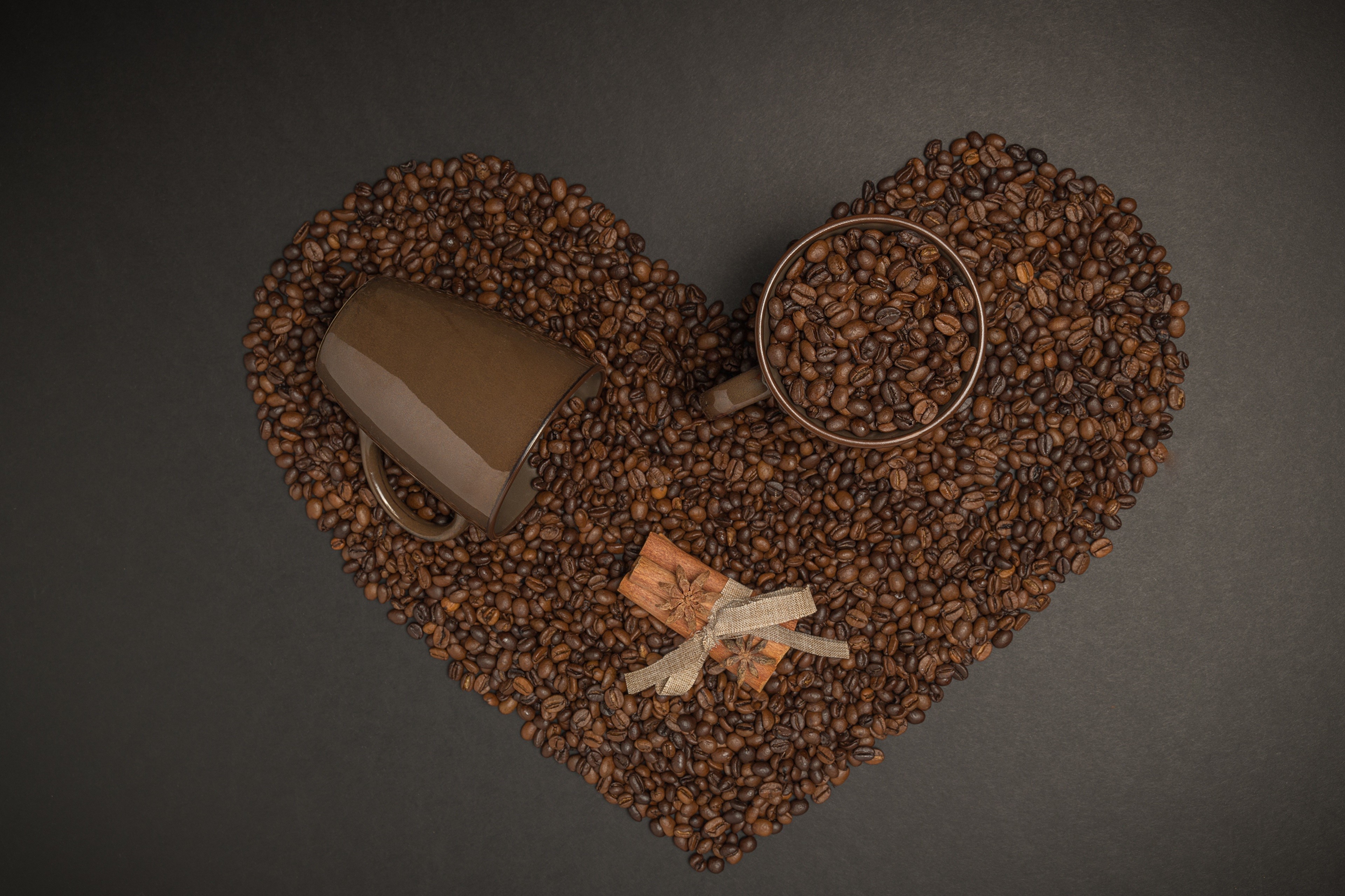 Coffee beans in a heart shape with mugs and cinnamon HD Wallpaper