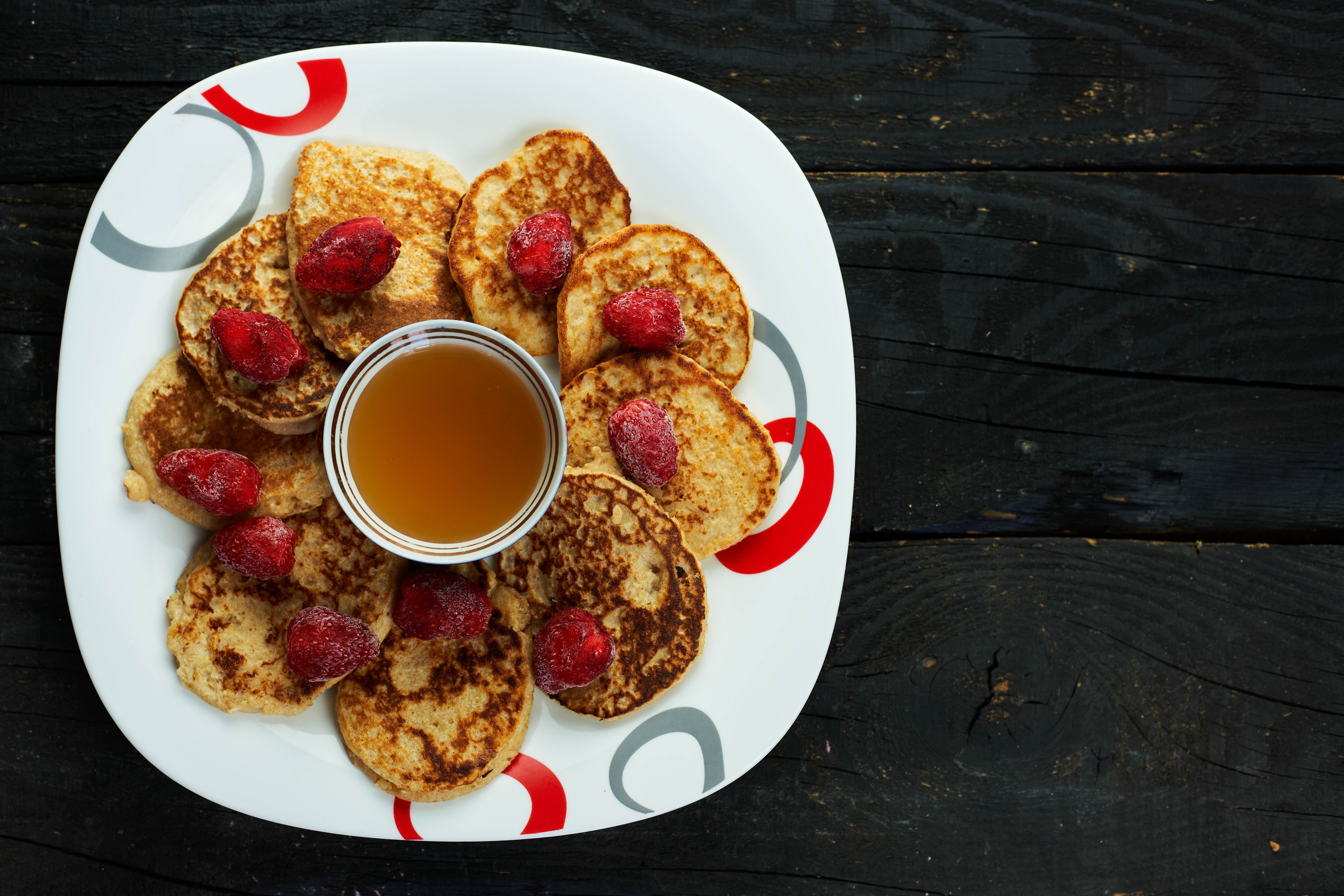 Pancakes with strawberries and honey on a plate HD Wallpaper