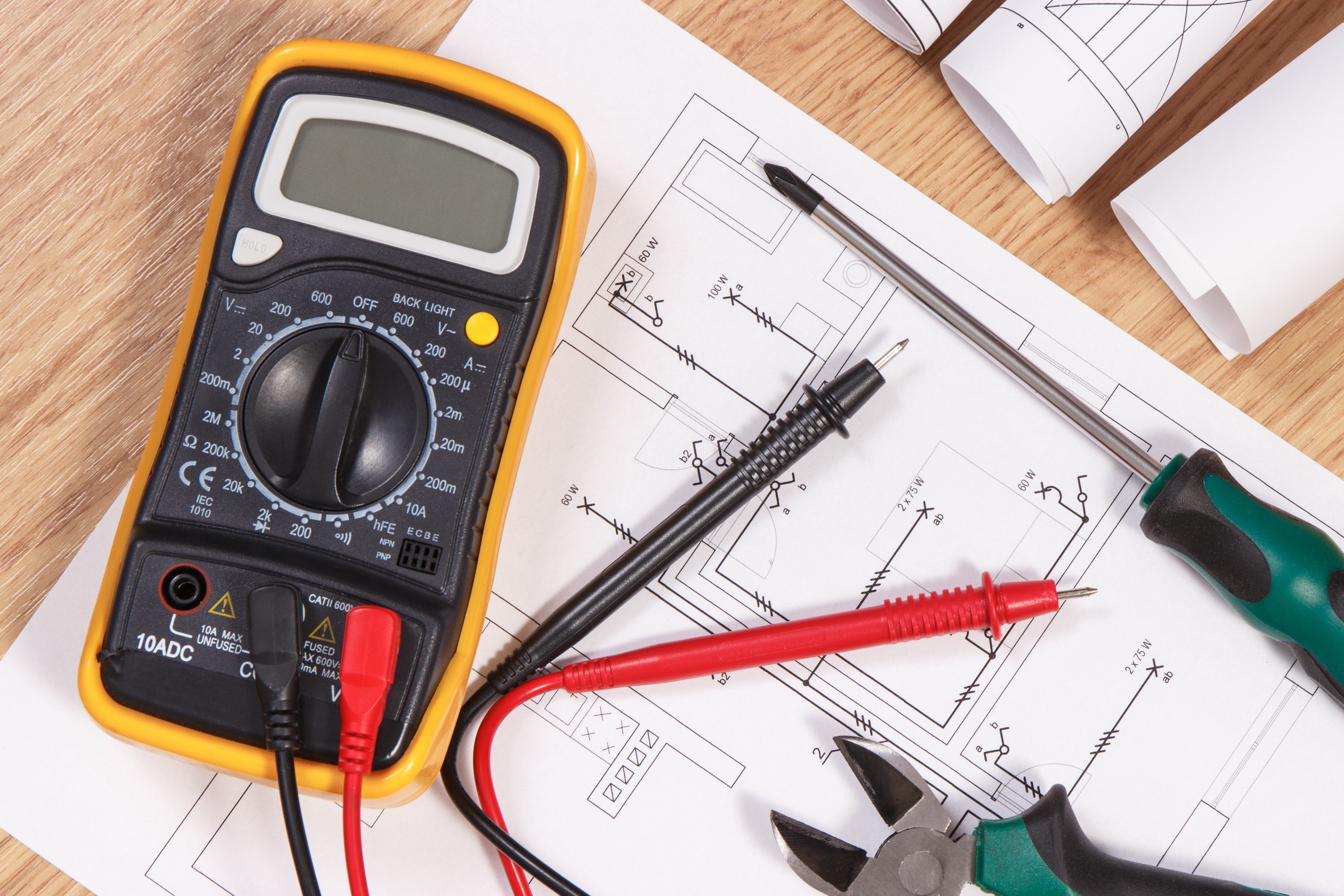 Multimeter and electrical plans on a table HD Wallpaper