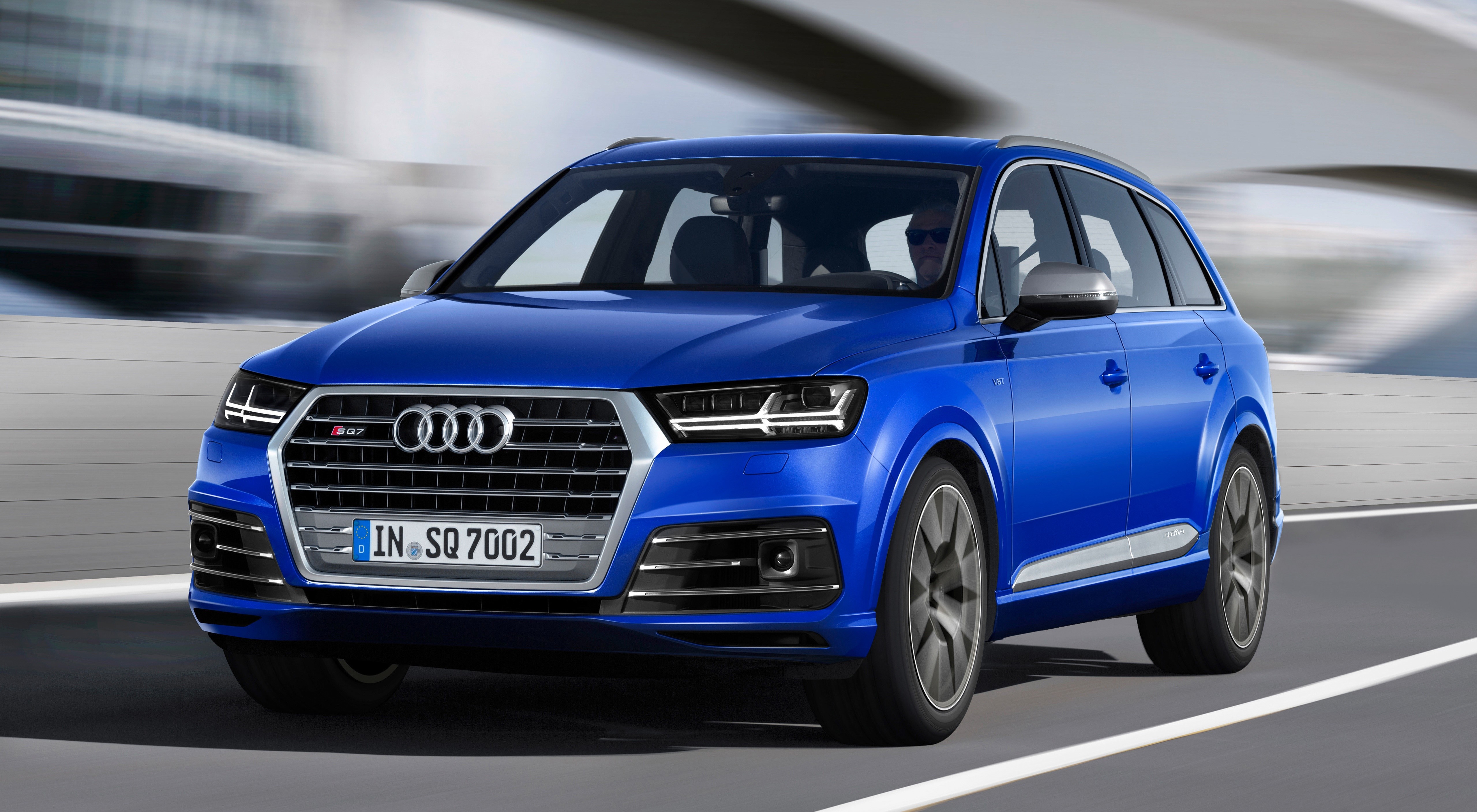 Blue Audi SQ7 TDI driving on a road HD Wallpaper