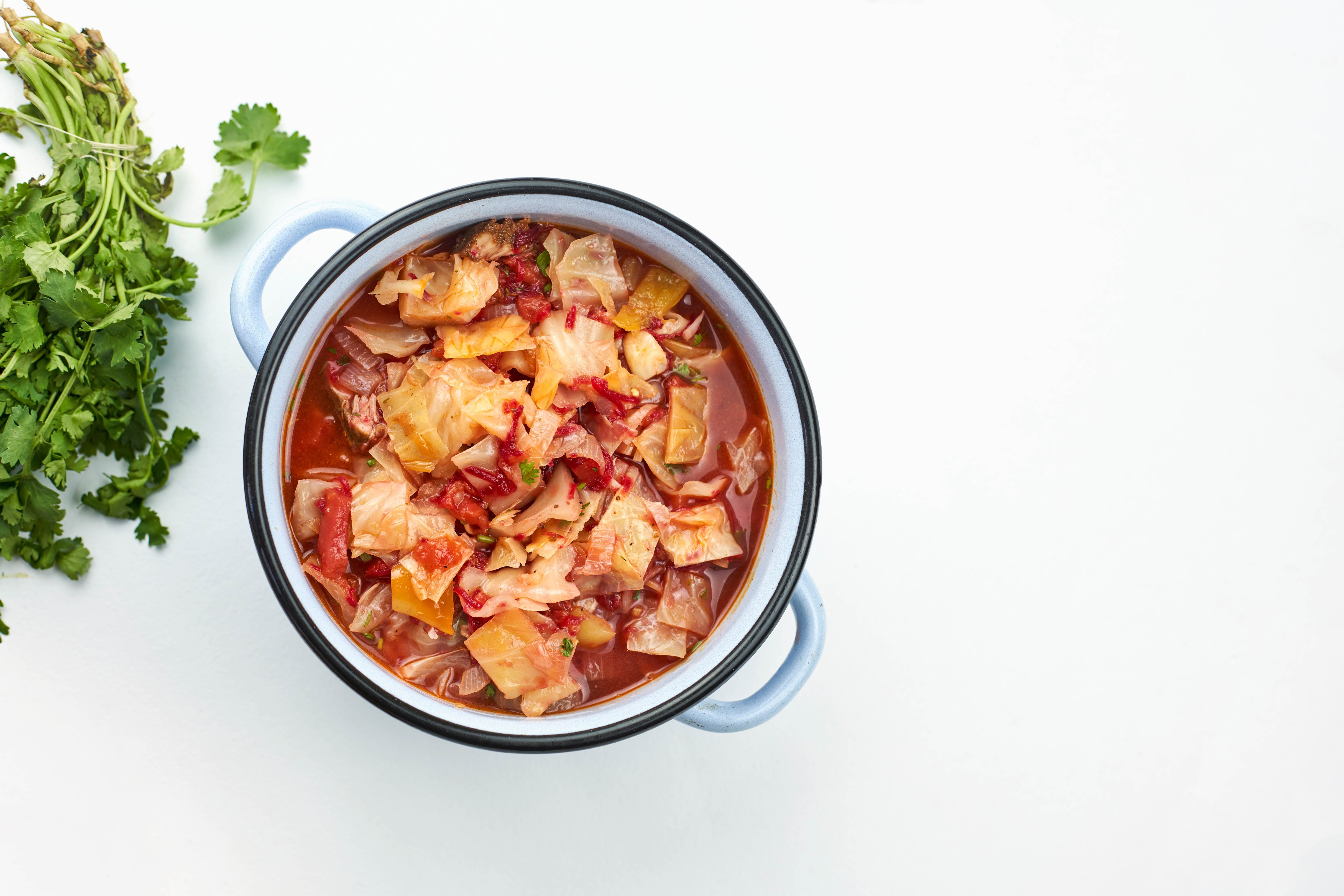 Cabbage soup in a pot with cilantro HD Wallpaper
