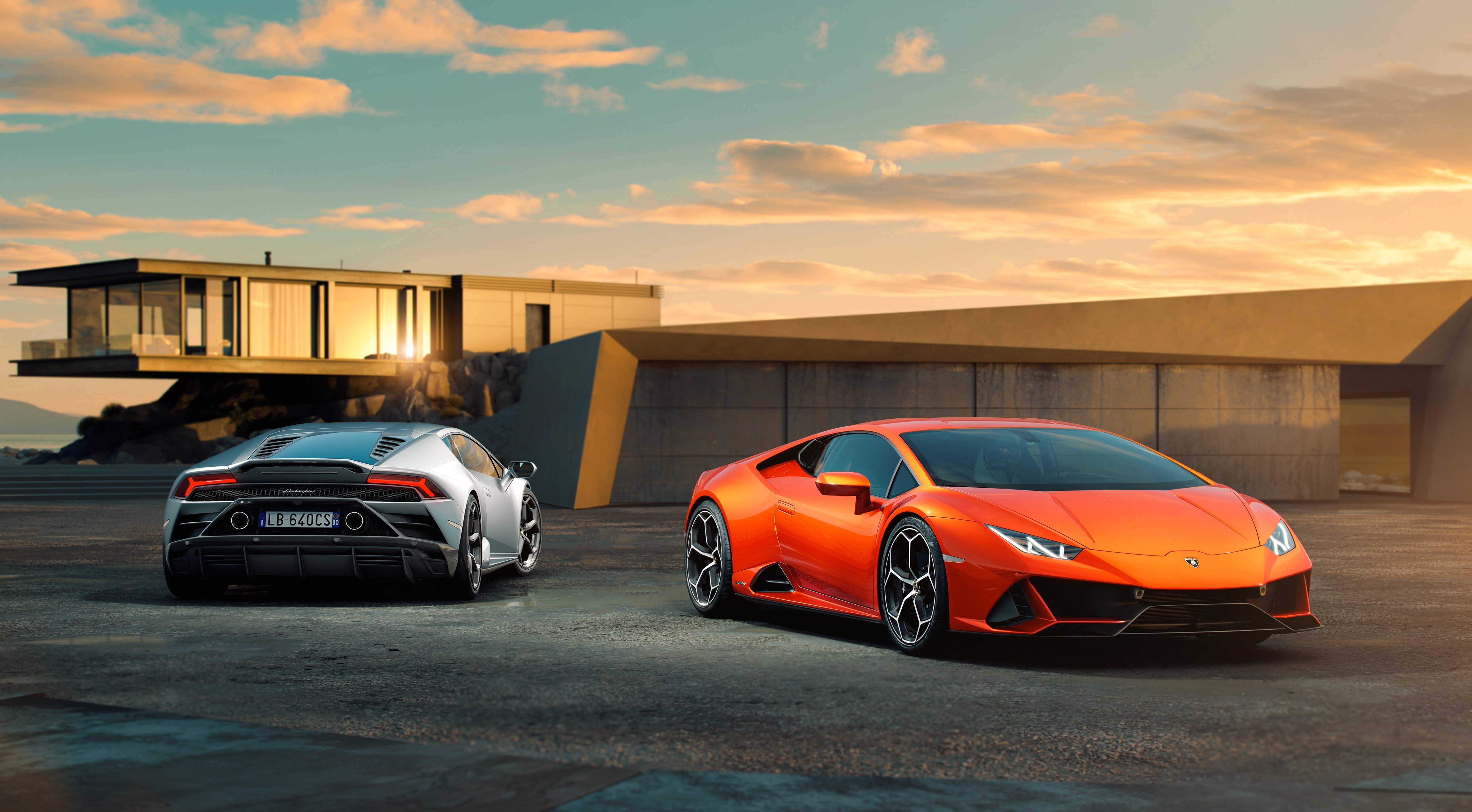 Two Lamborghini Huracan EVO cars parked near a modern house HD Wallpaper
