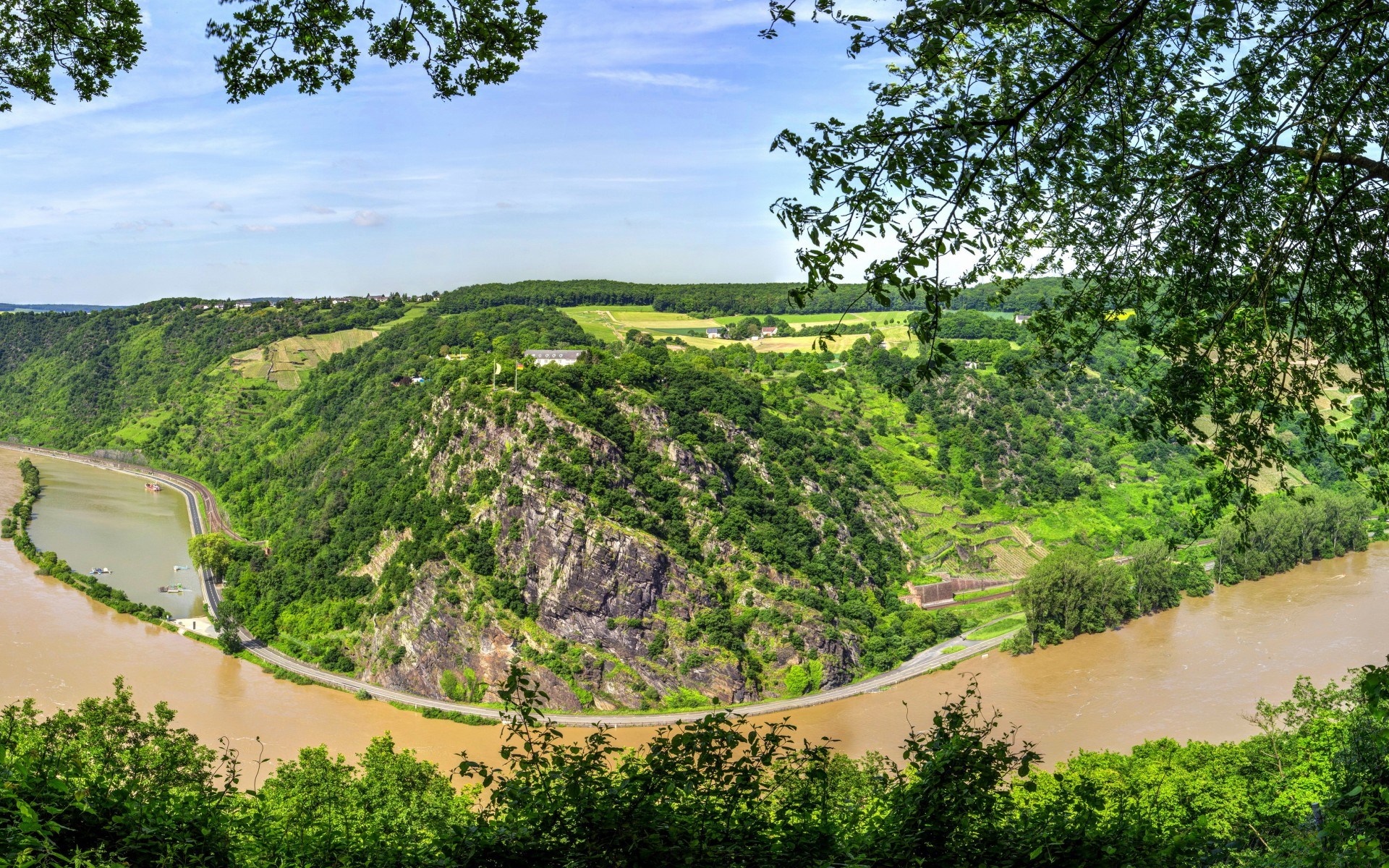 River valley with steep, forested hills and a winding river HD Wallpaper