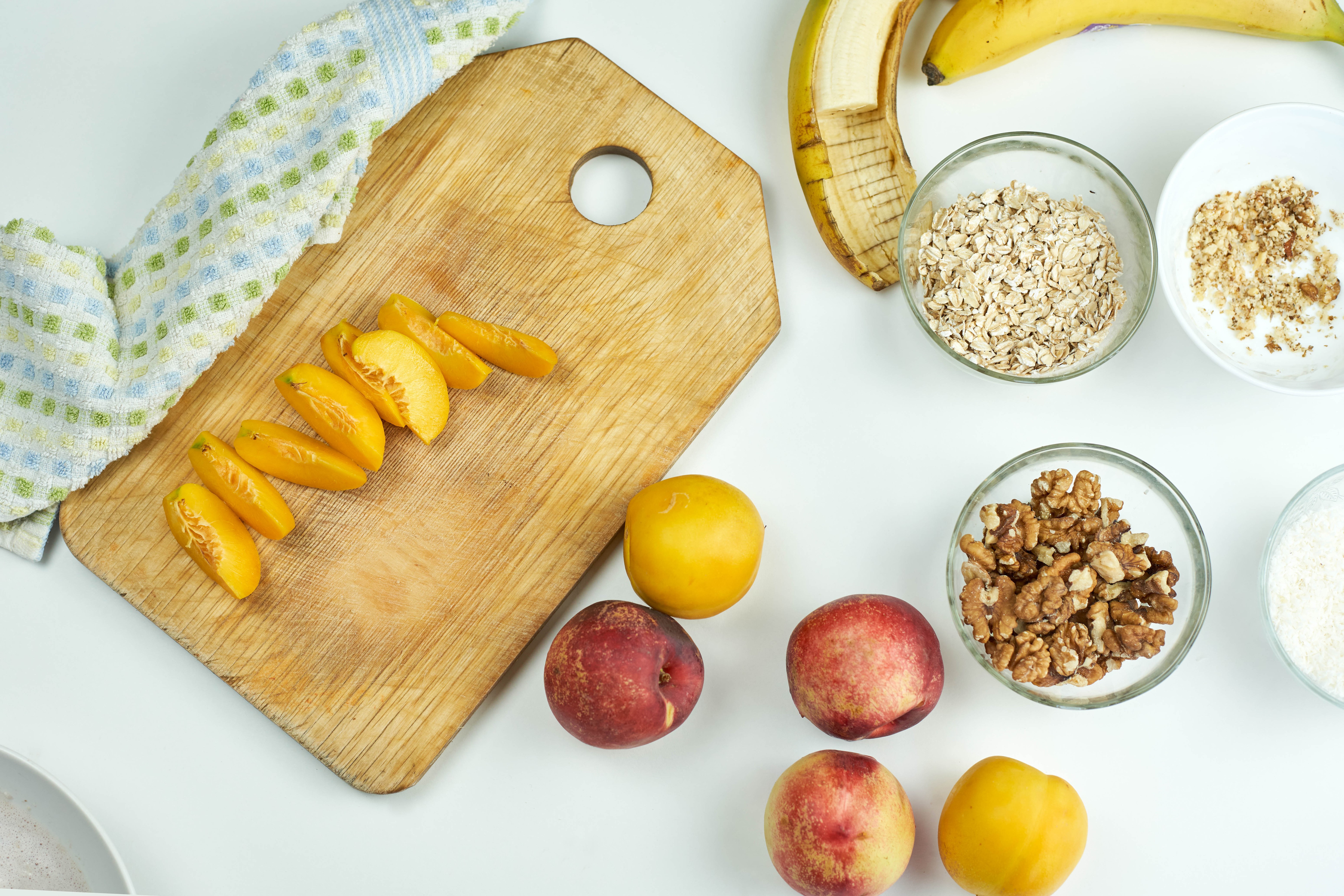 Peaches, Plums, Walnuts, Muesli, and Banana on Cutting Board HD Wallpaper