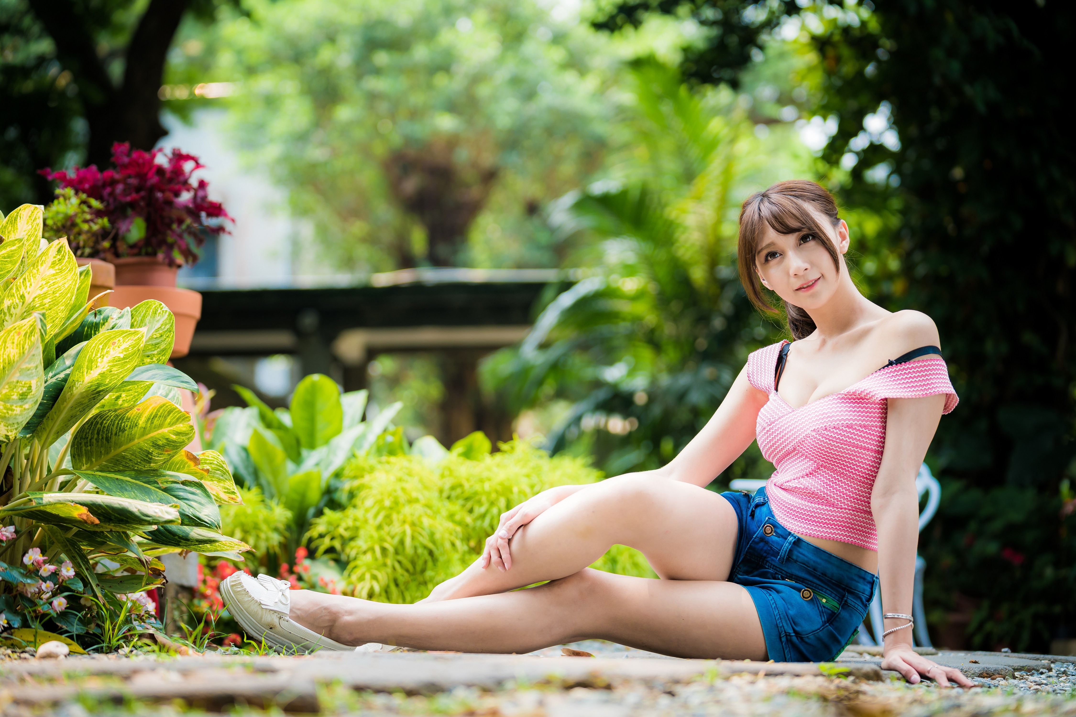 4K Asian Woman Sitting Outdoors in Shorts HD Wallpaper