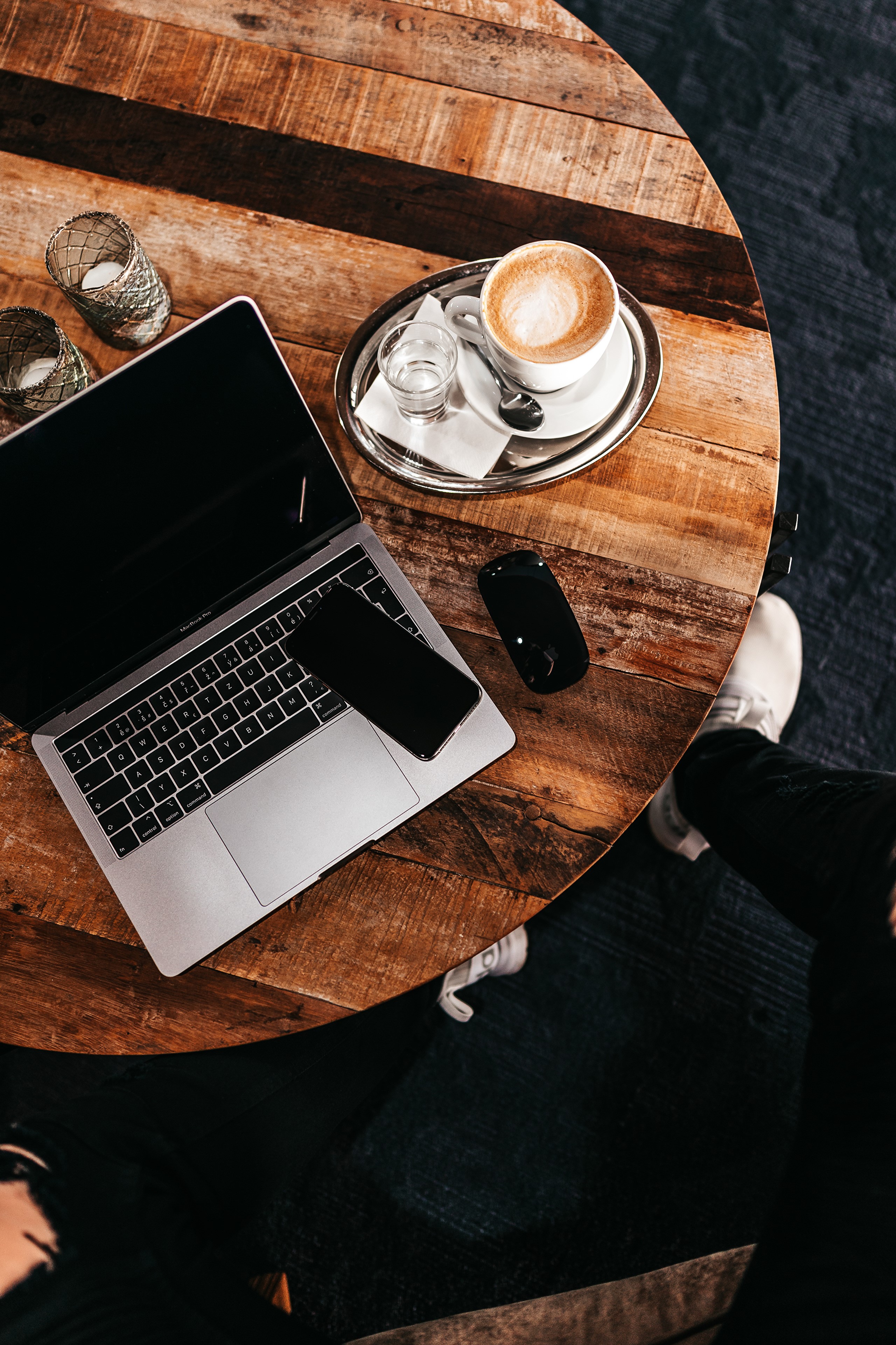 Laptop, Smartphone, Coffee, and Candles on a Wooden Table HD Phone Wallpaper