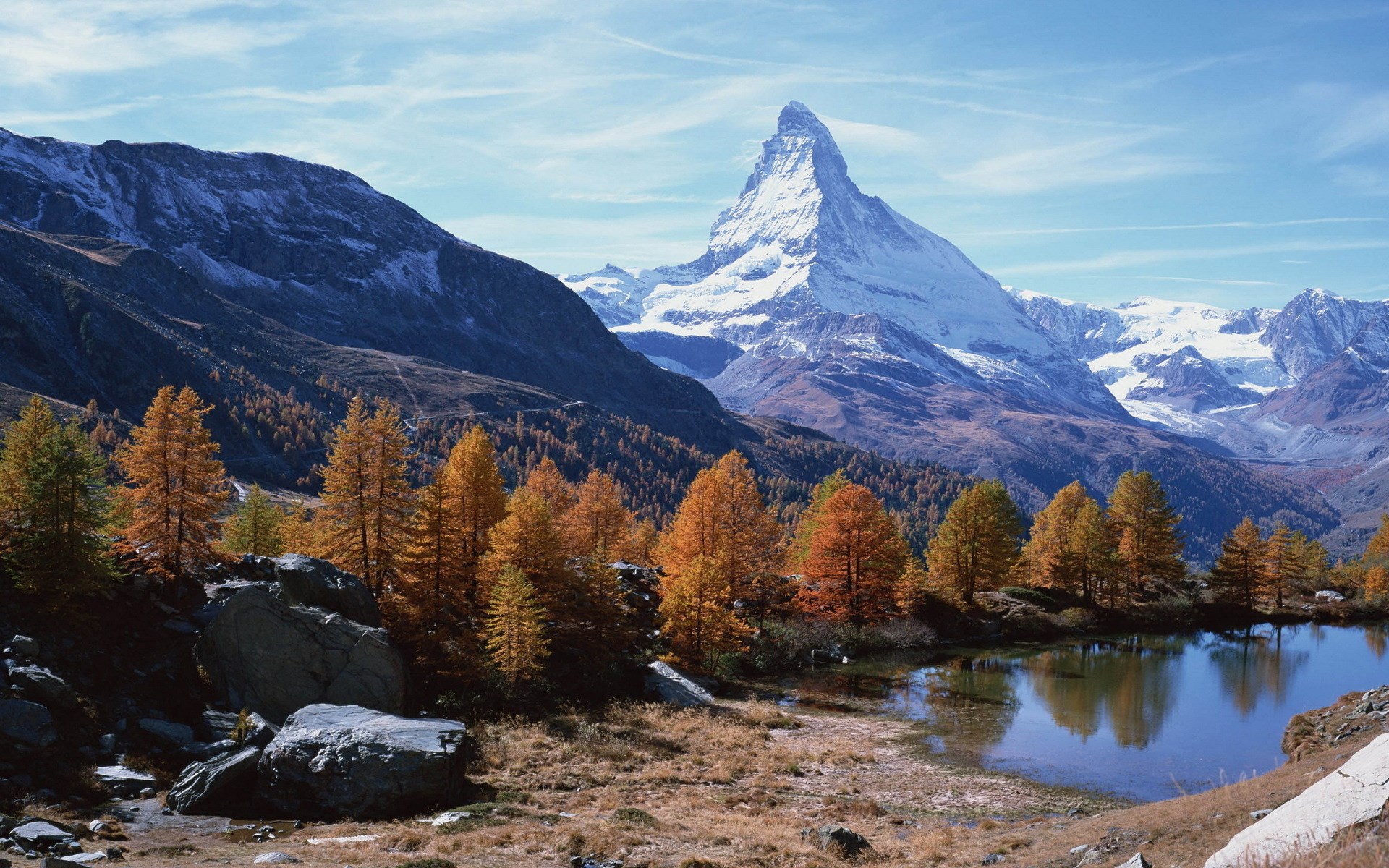 Matterhorn mountain reflected in a lake with autumn trees HD Wallpaper