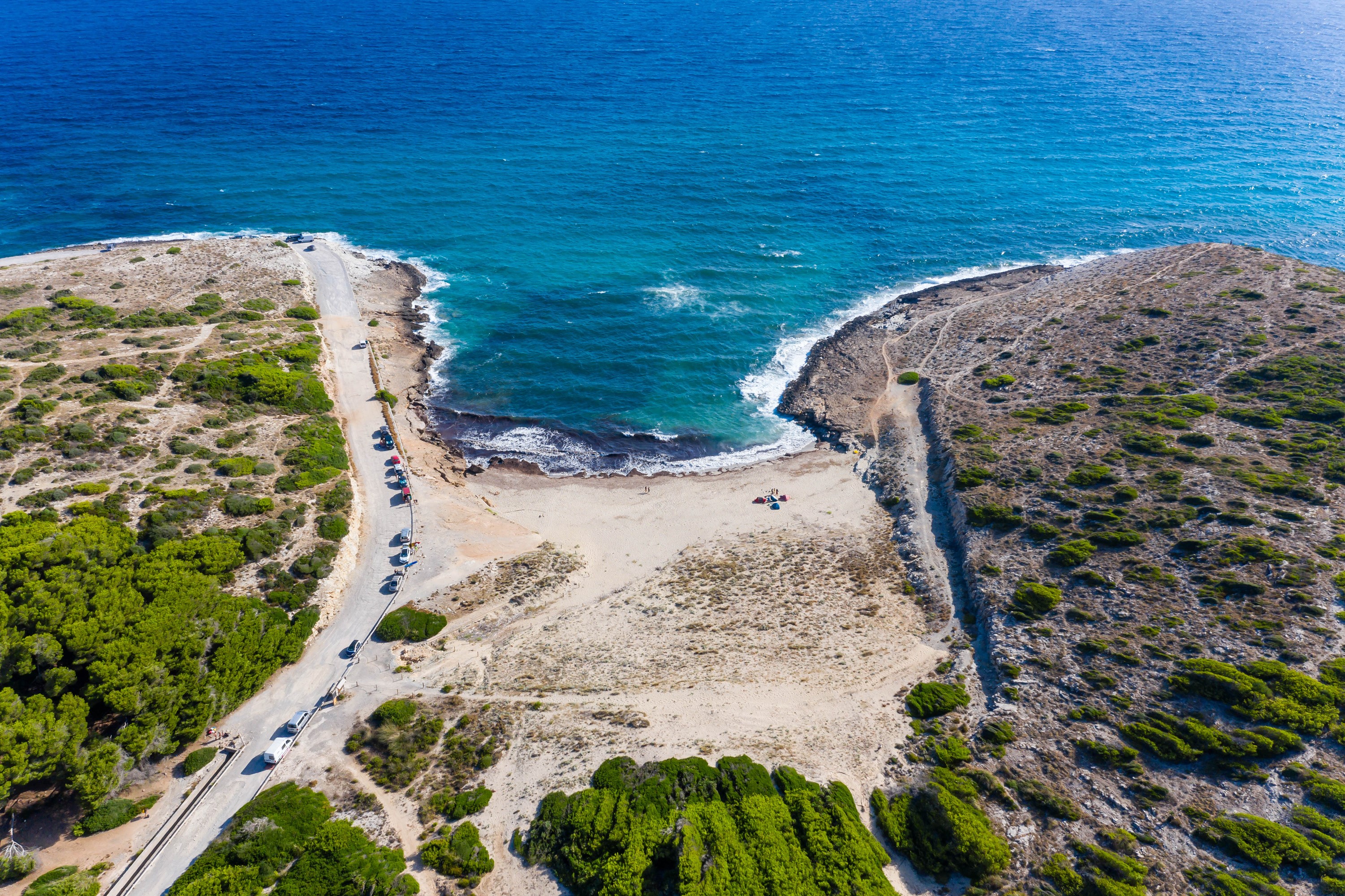 Aerial view of a bay with a road and trees in Mallorca HD Wallpaper
