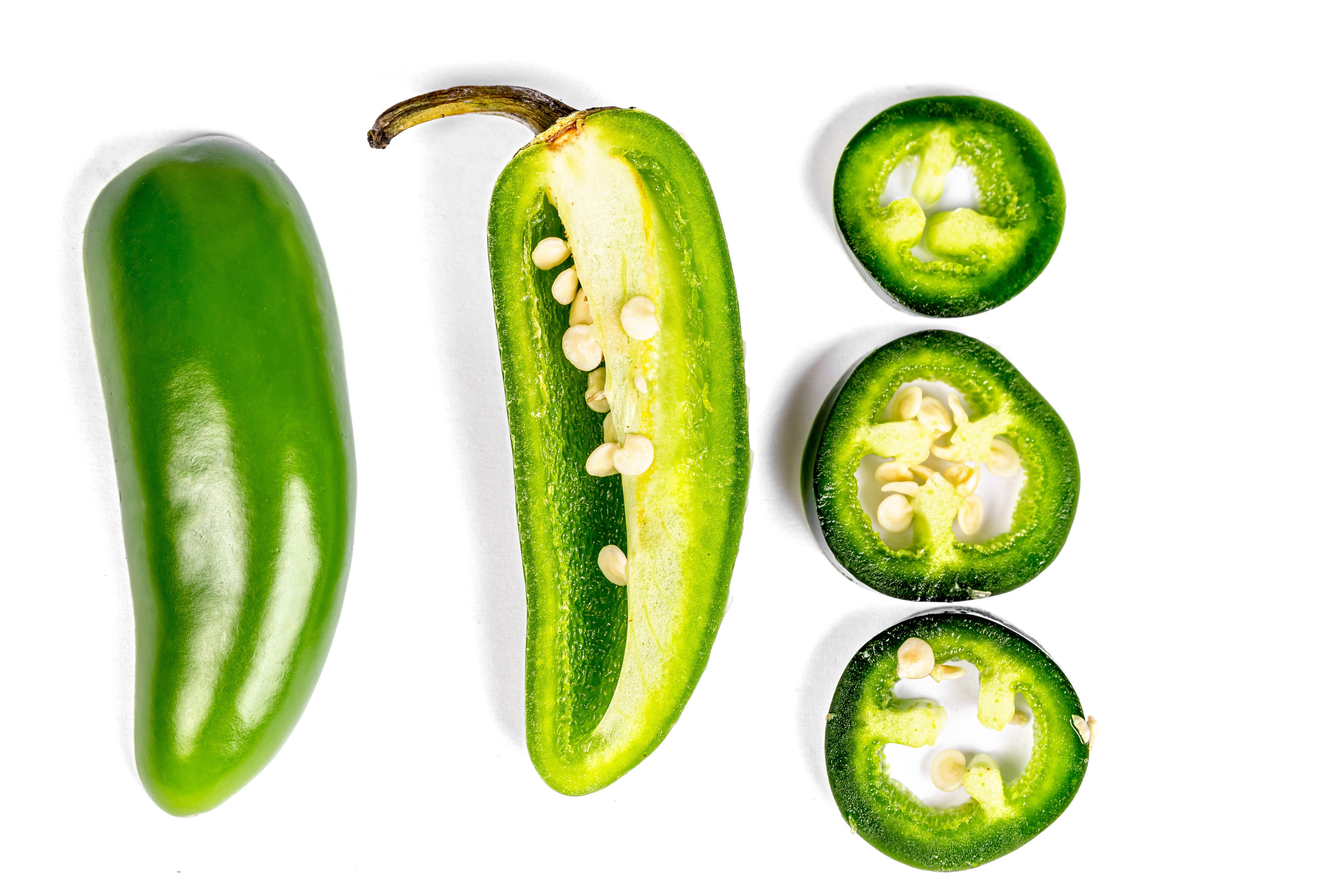 Jalapeno pepper, whole and sliced HD Wallpaper