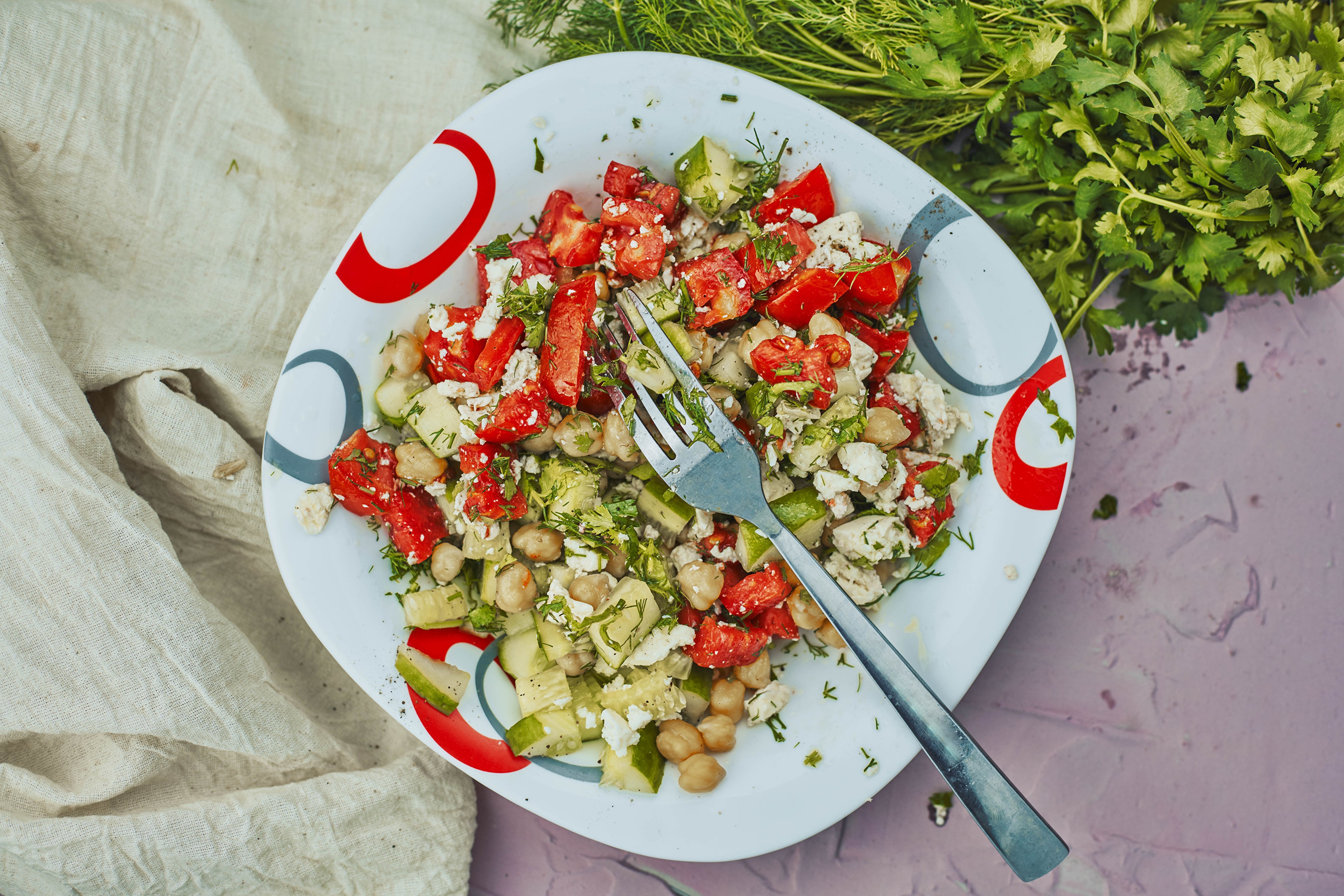 Salad with tomatoes, cucumbers, chickpeas, and feta cheese on a plate HD Wallpaper