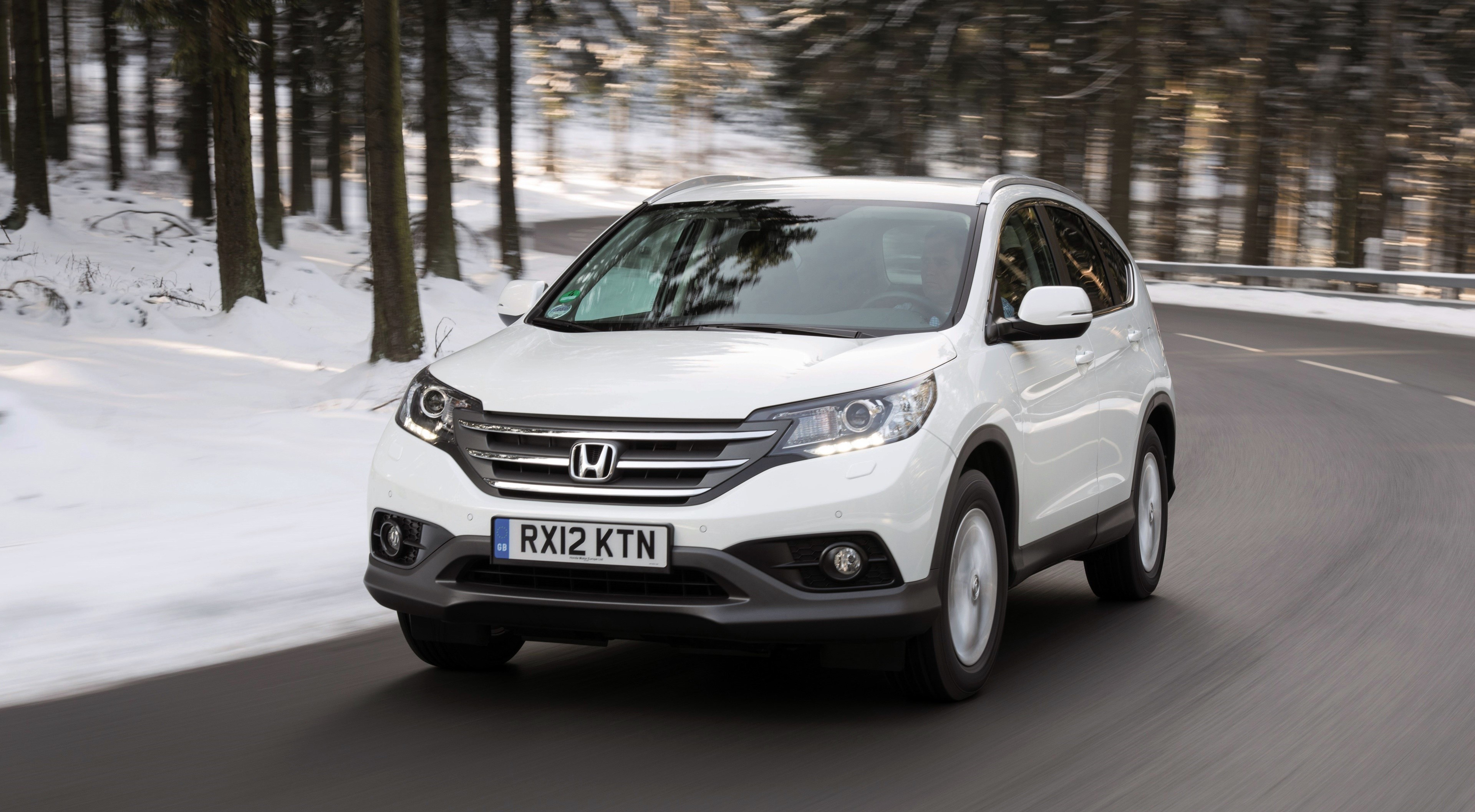 White Honda CR-V driving on a snowy road HD Wallpaper