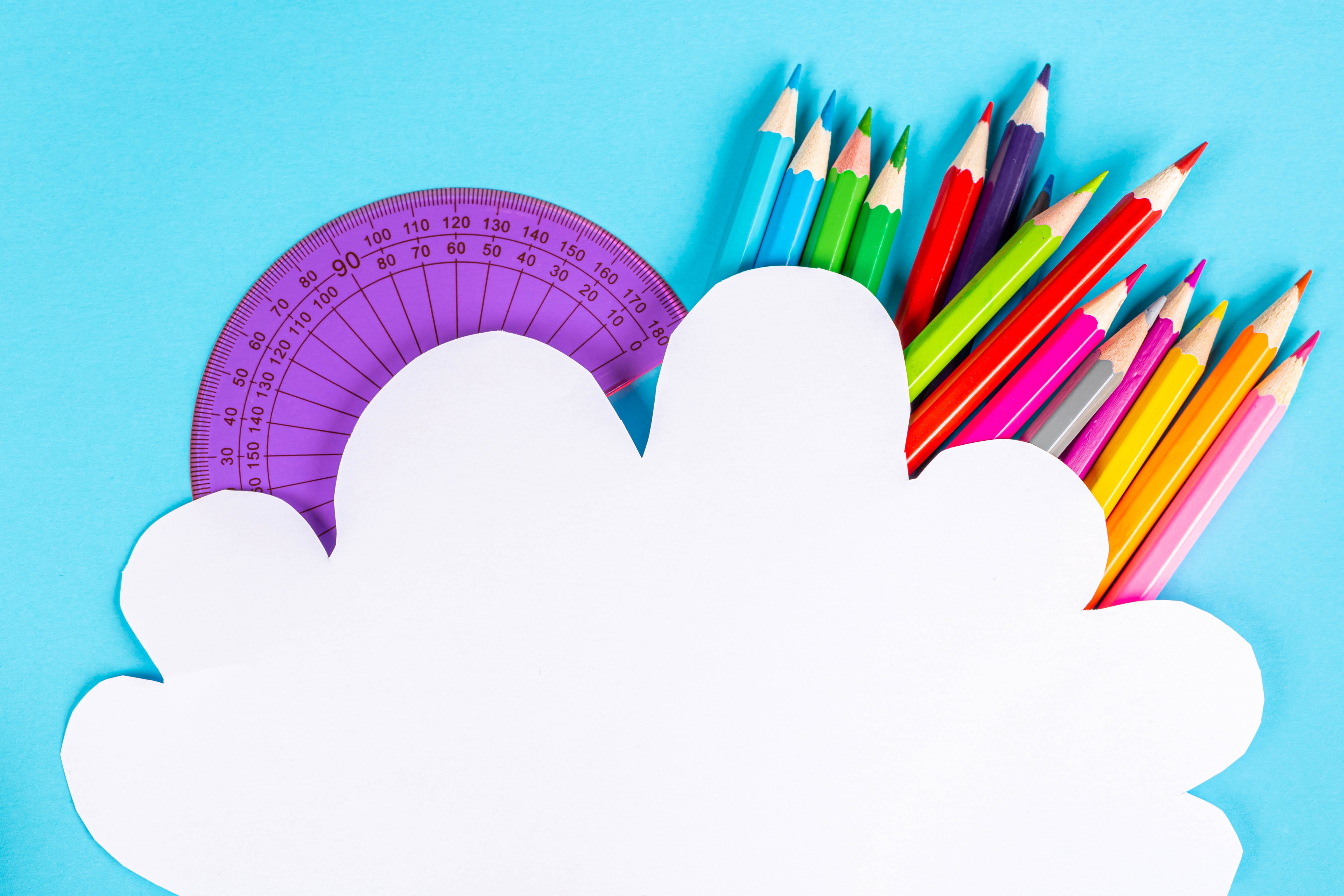 Colored pencils and protractor on blue background HD Wallpaper