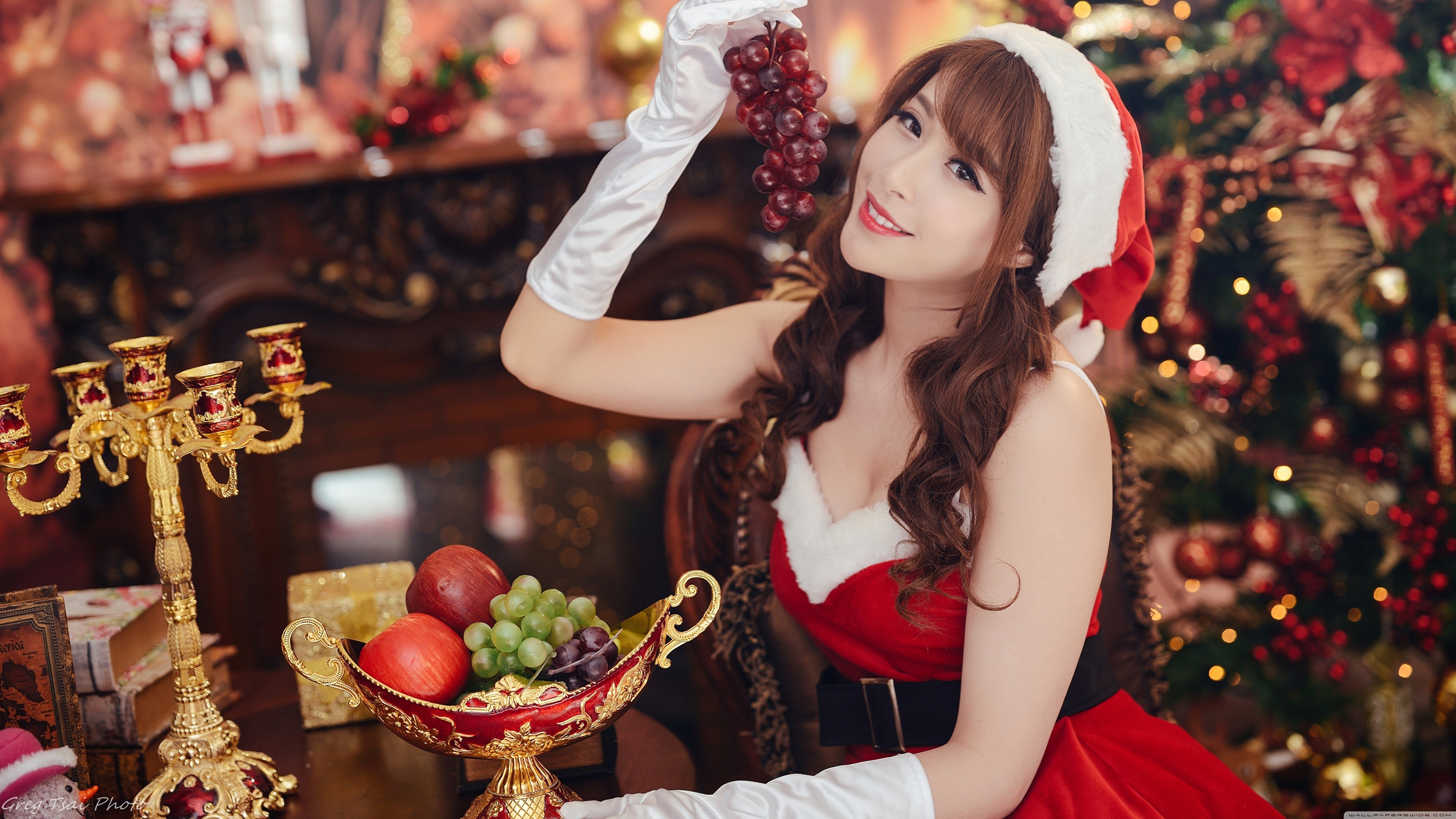 4K Christmas Joy with Asian Woman in Santa Outfit HD Wallpaper