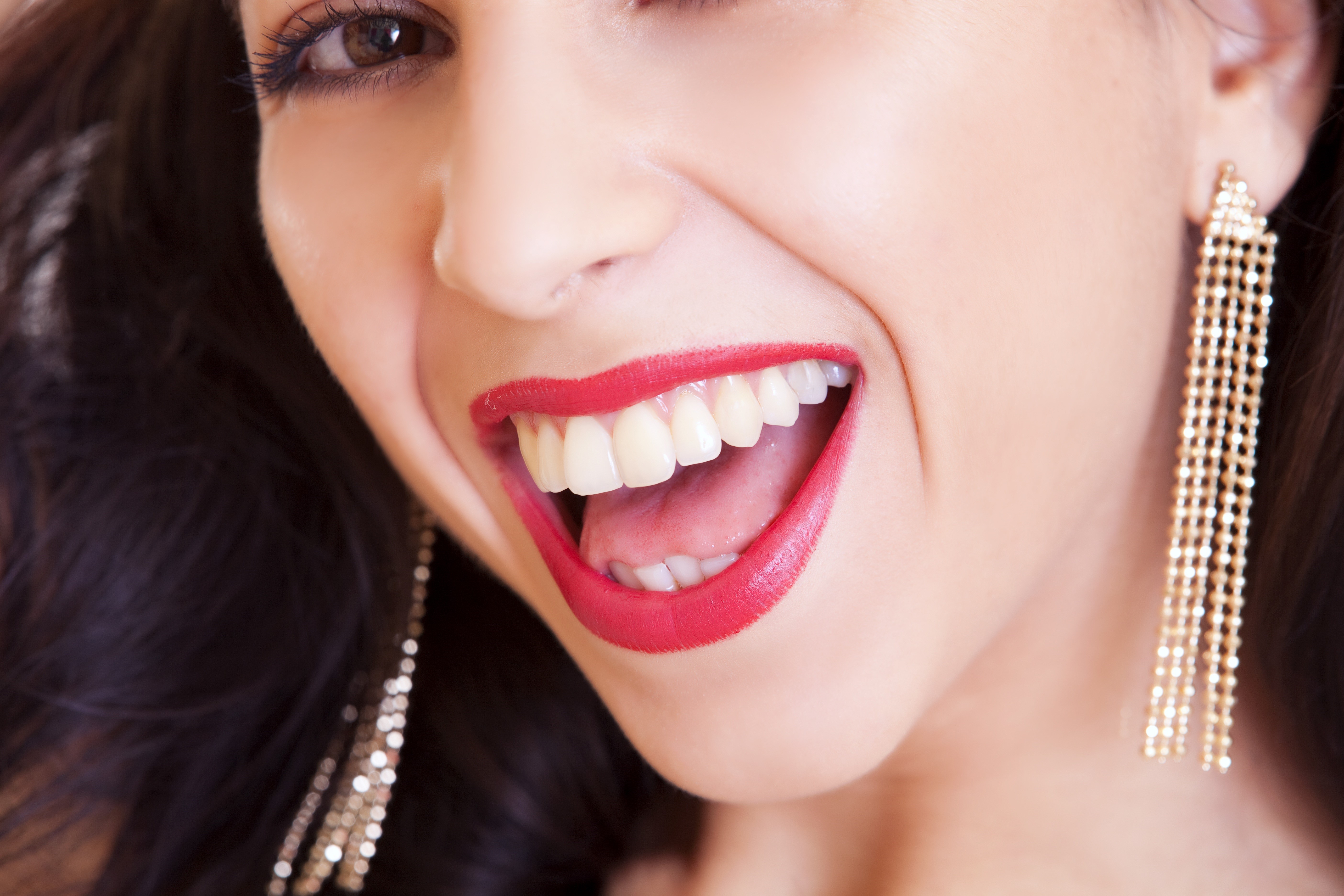 Woman with red lips and earrings laughing HD Wallpaper
