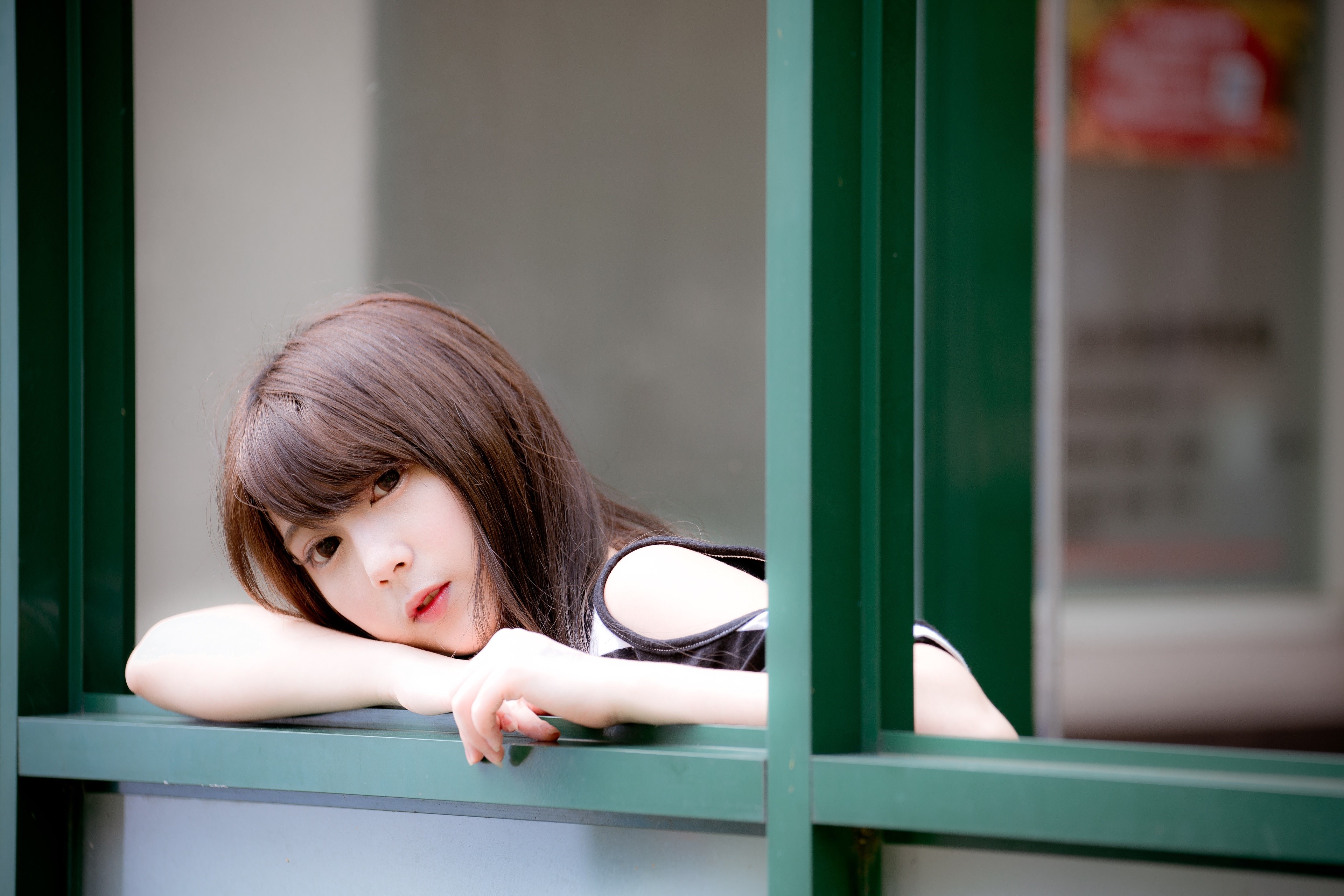 Asian girl with brown hair leaning on a window HD Wallpaper