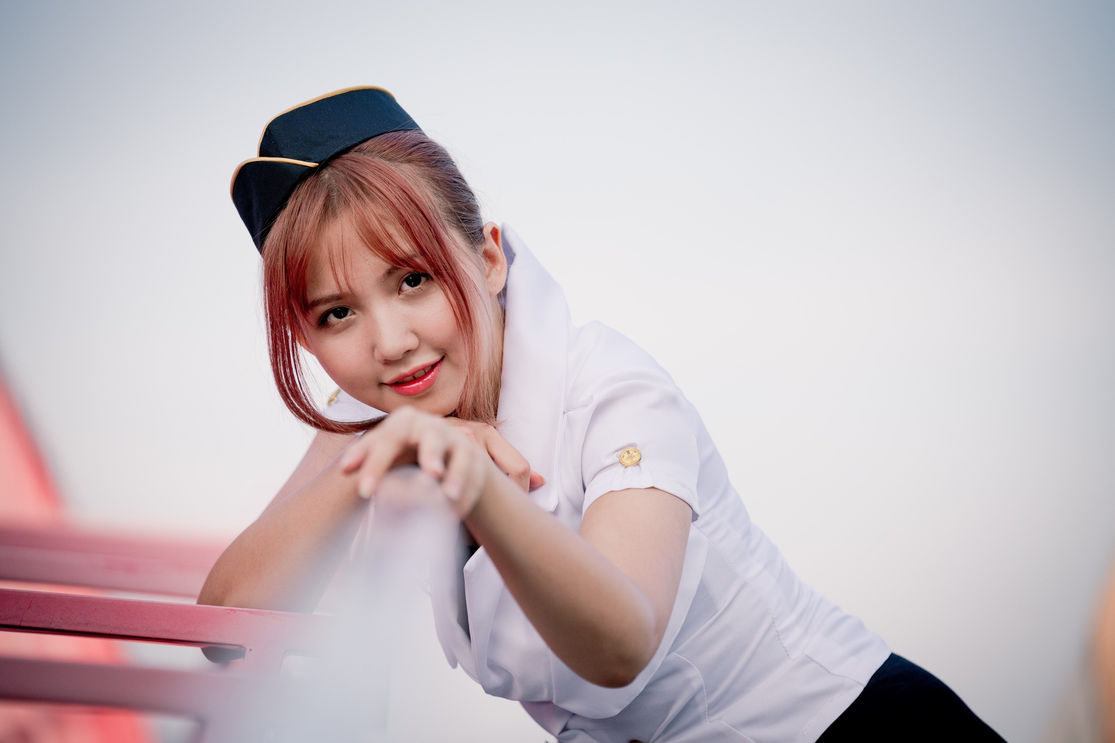 Asian stewardess with red hair and a smile HD Wallpaper