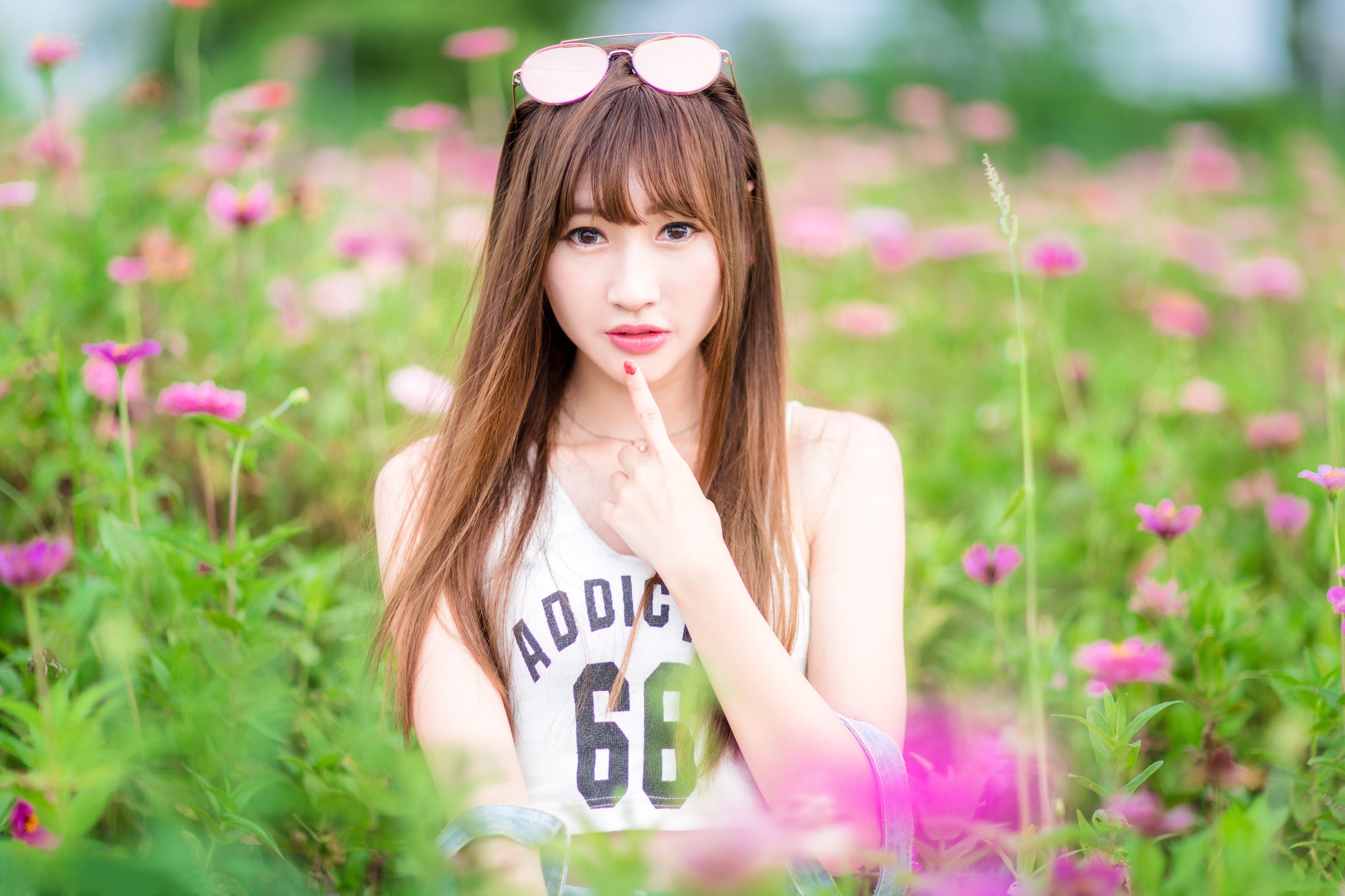 Asian woman with brown hair in a flower field HD Wallpaper