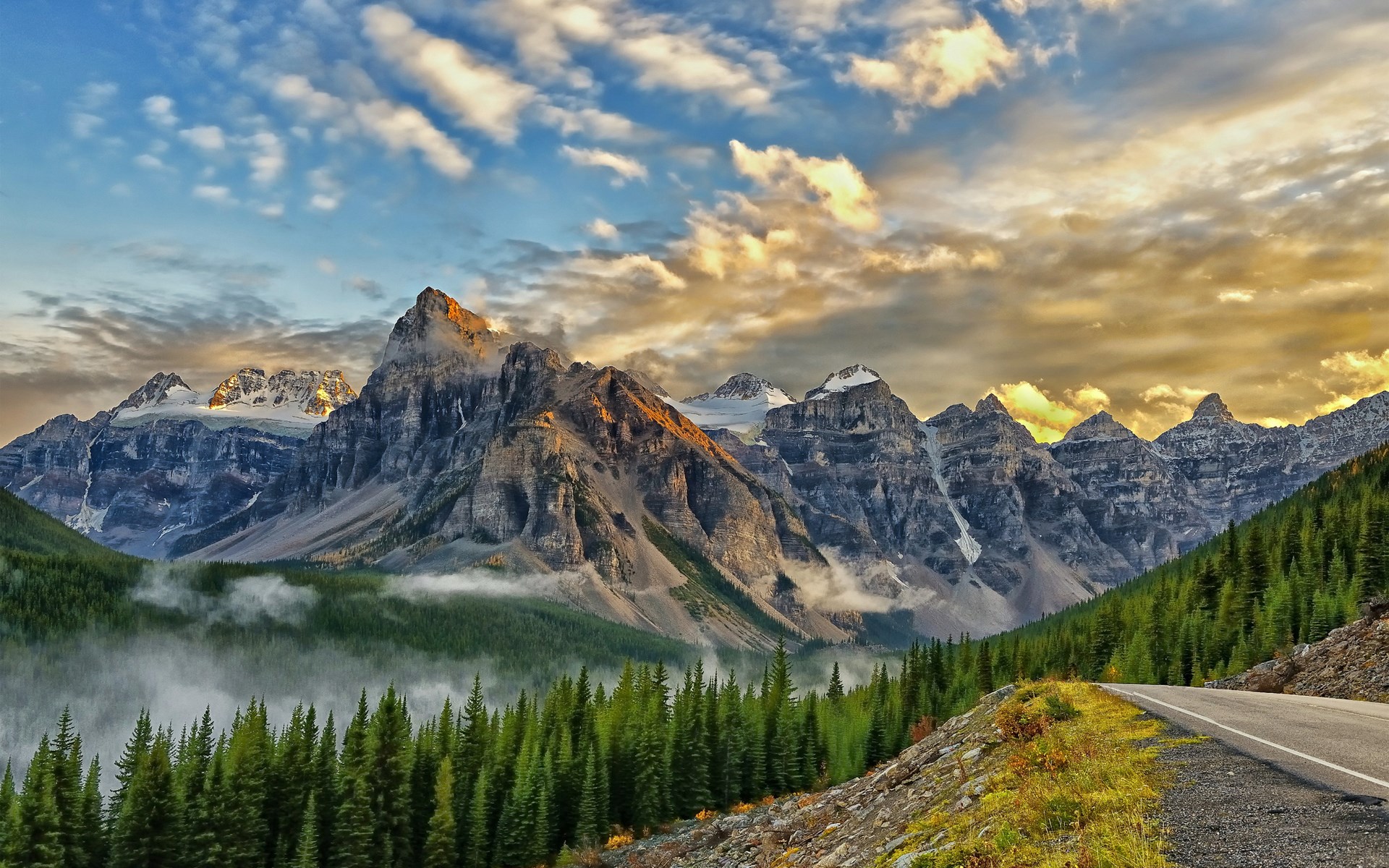 Mountain range with pine forest and road HD Wallpaper