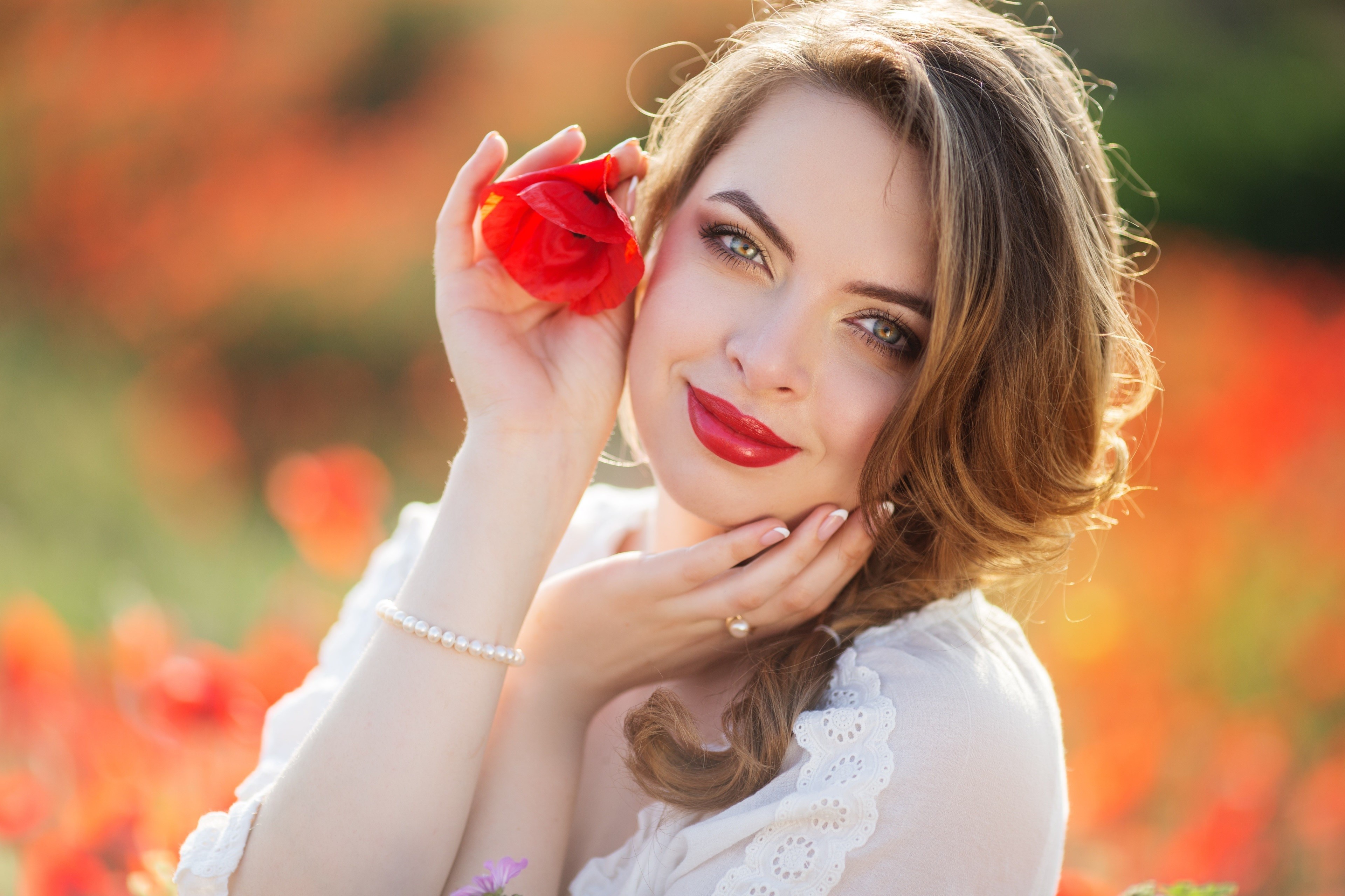 Woman with red poppy and pearl bracelet HD Wallpaper