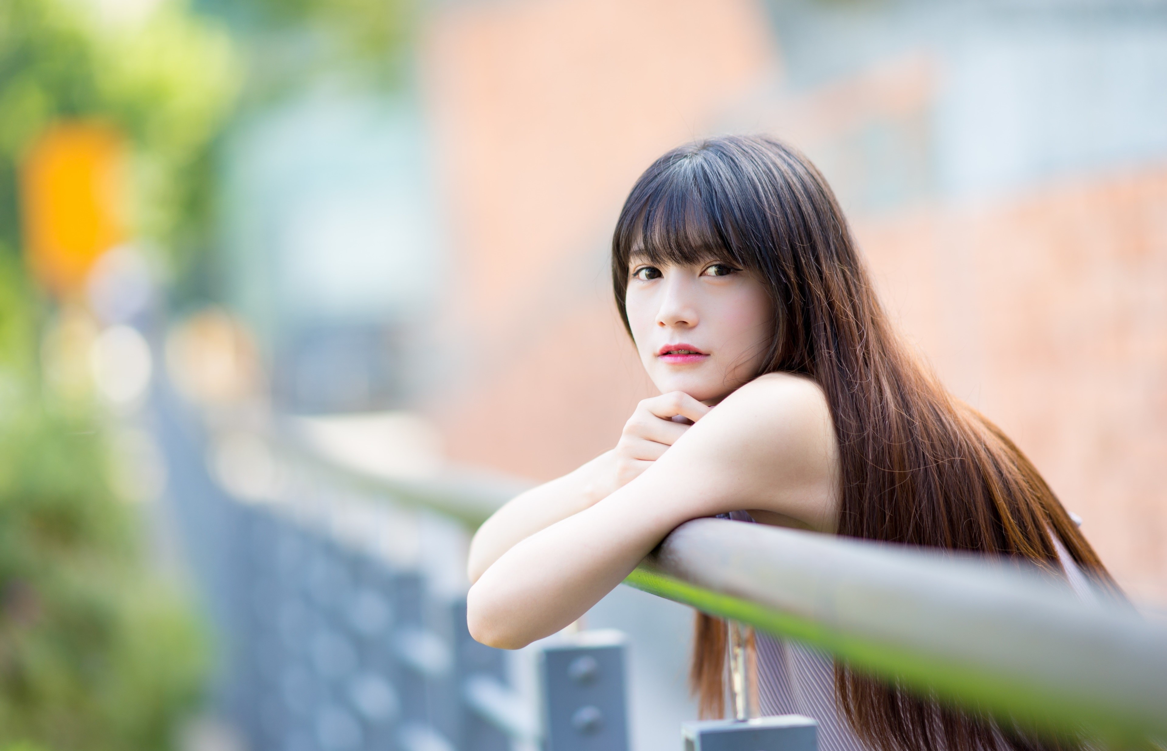 Asian Woman with Long Brown Hair Leaning on Railing HD Wallpaper