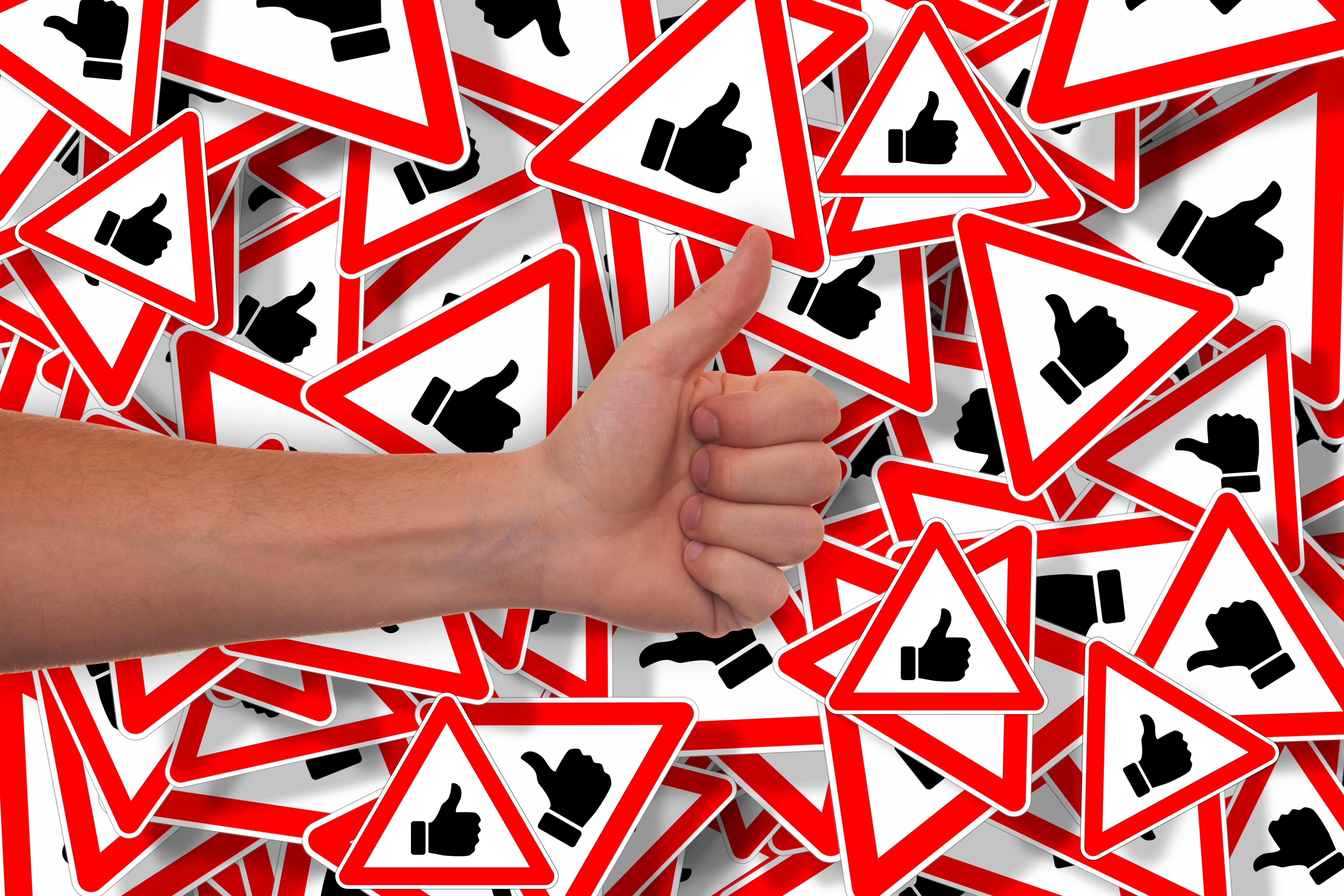 Hand giving thumbs up over like signs HD Wallpaper
