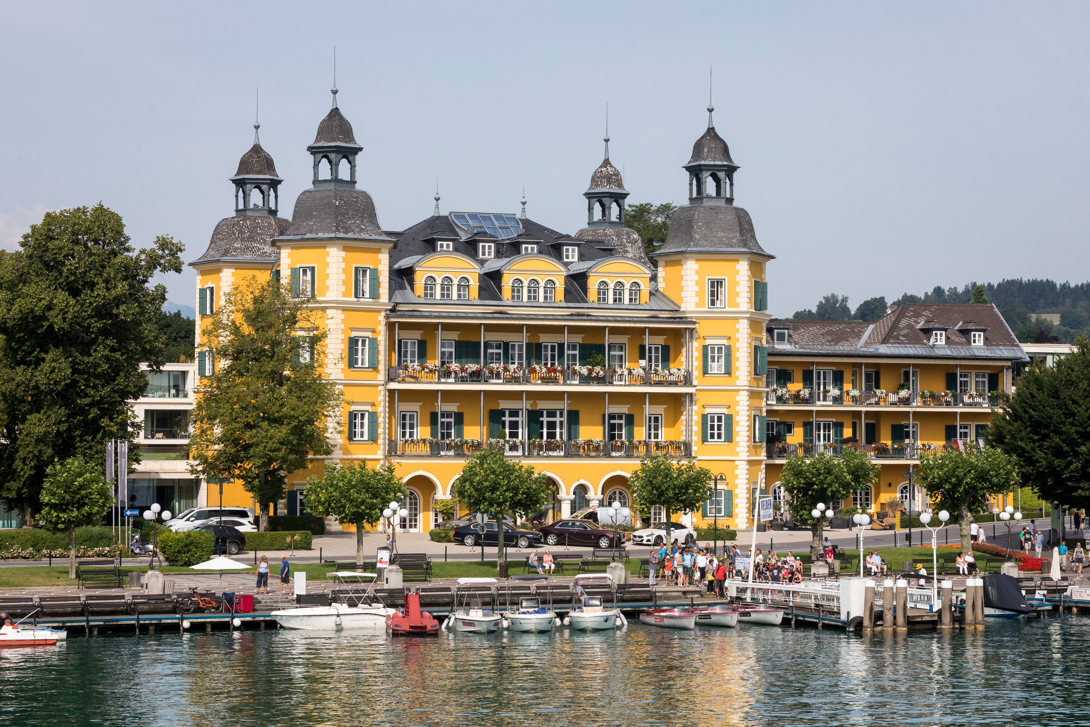 Yellow hotel building on a lake in Austria HD Wallpaper
