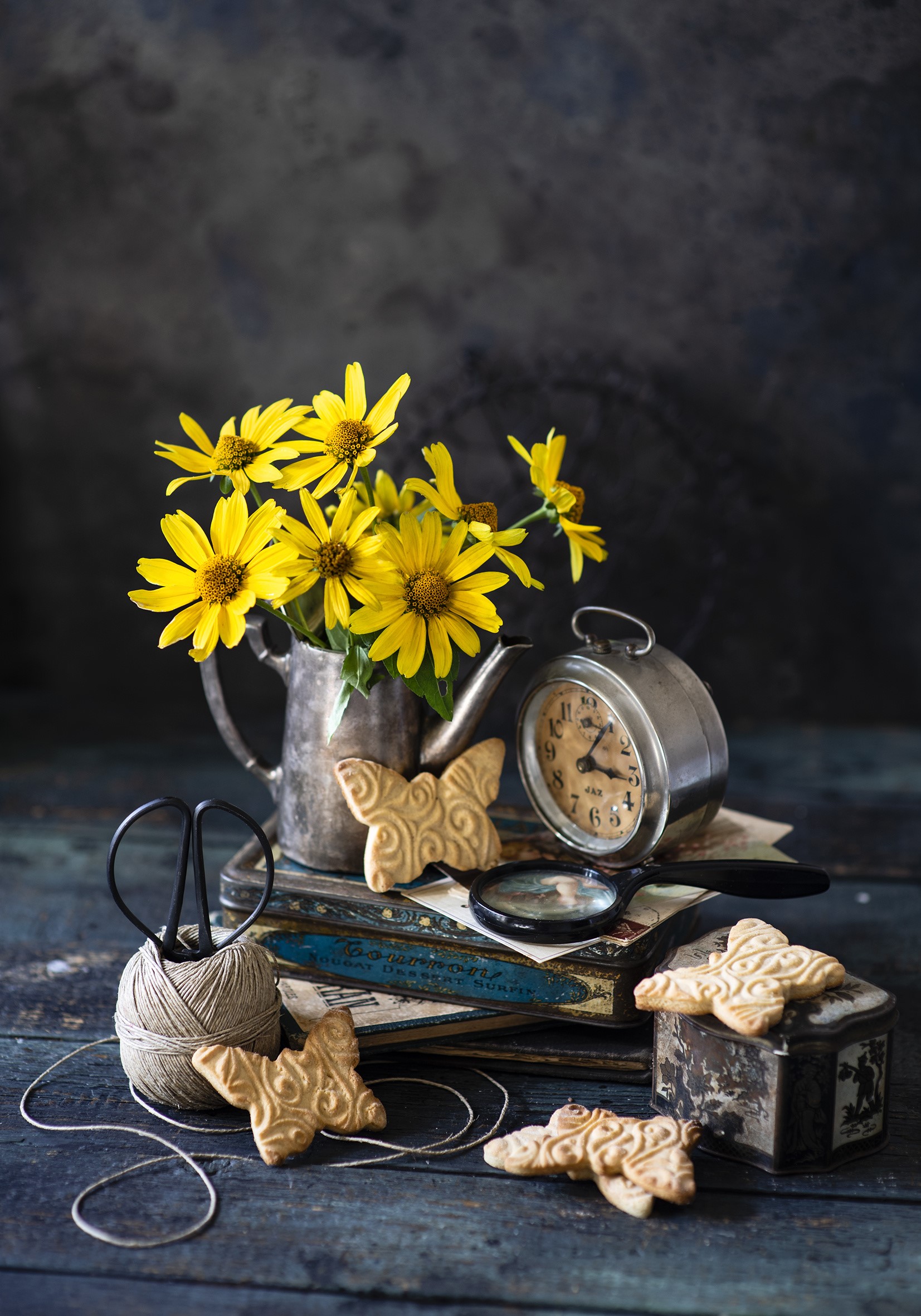 Still life with yellow flowers, cookies, and alarm clock HD Phone Wallpaper