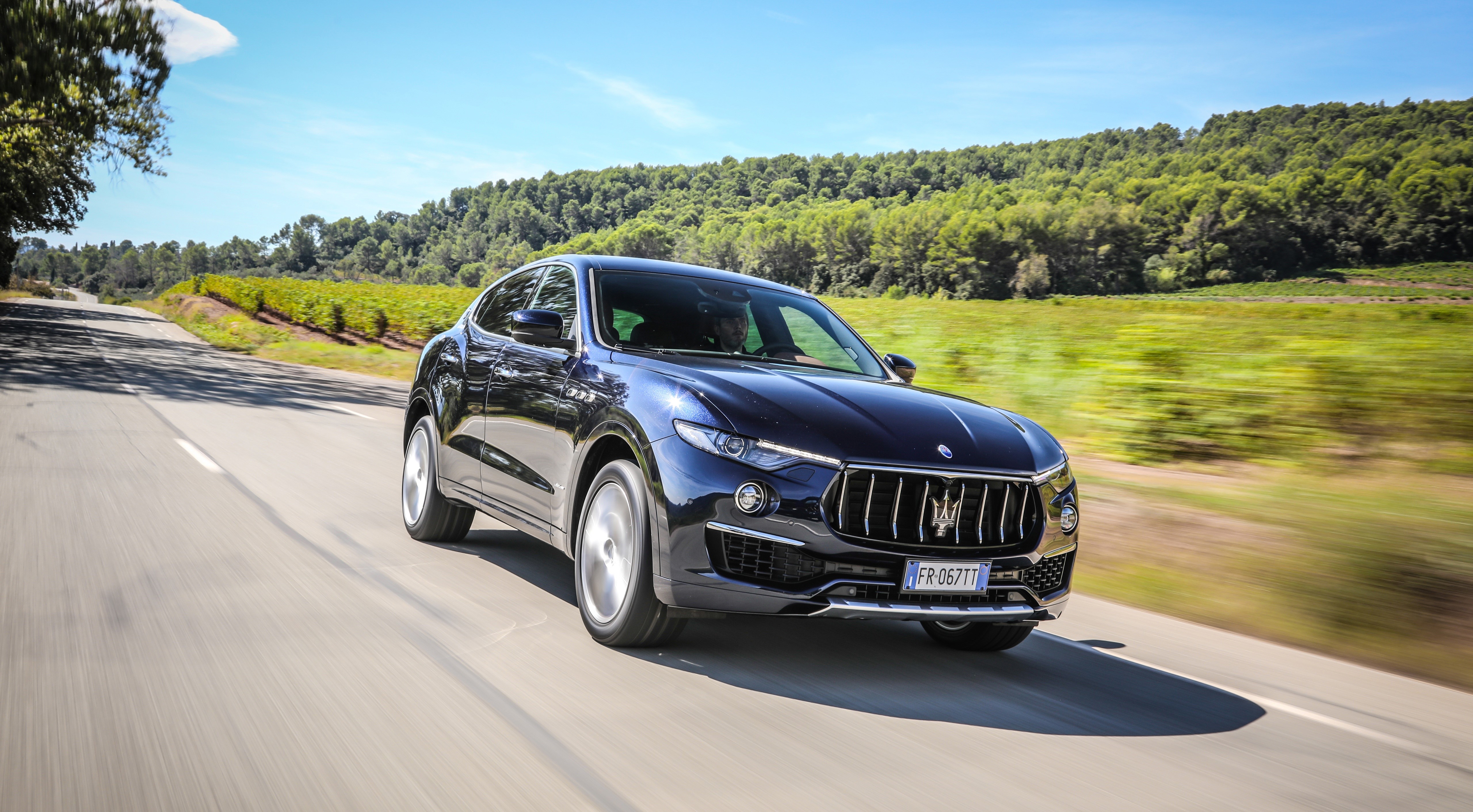 Maserati Levante S Q4 GranLusso driving on a road HD Wallpaper