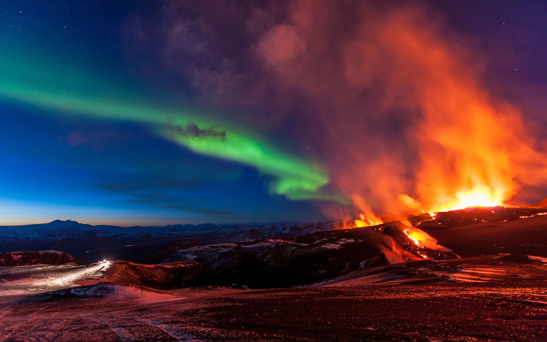 Aurora Borealis over a volcanic eruption HD Wallpaper