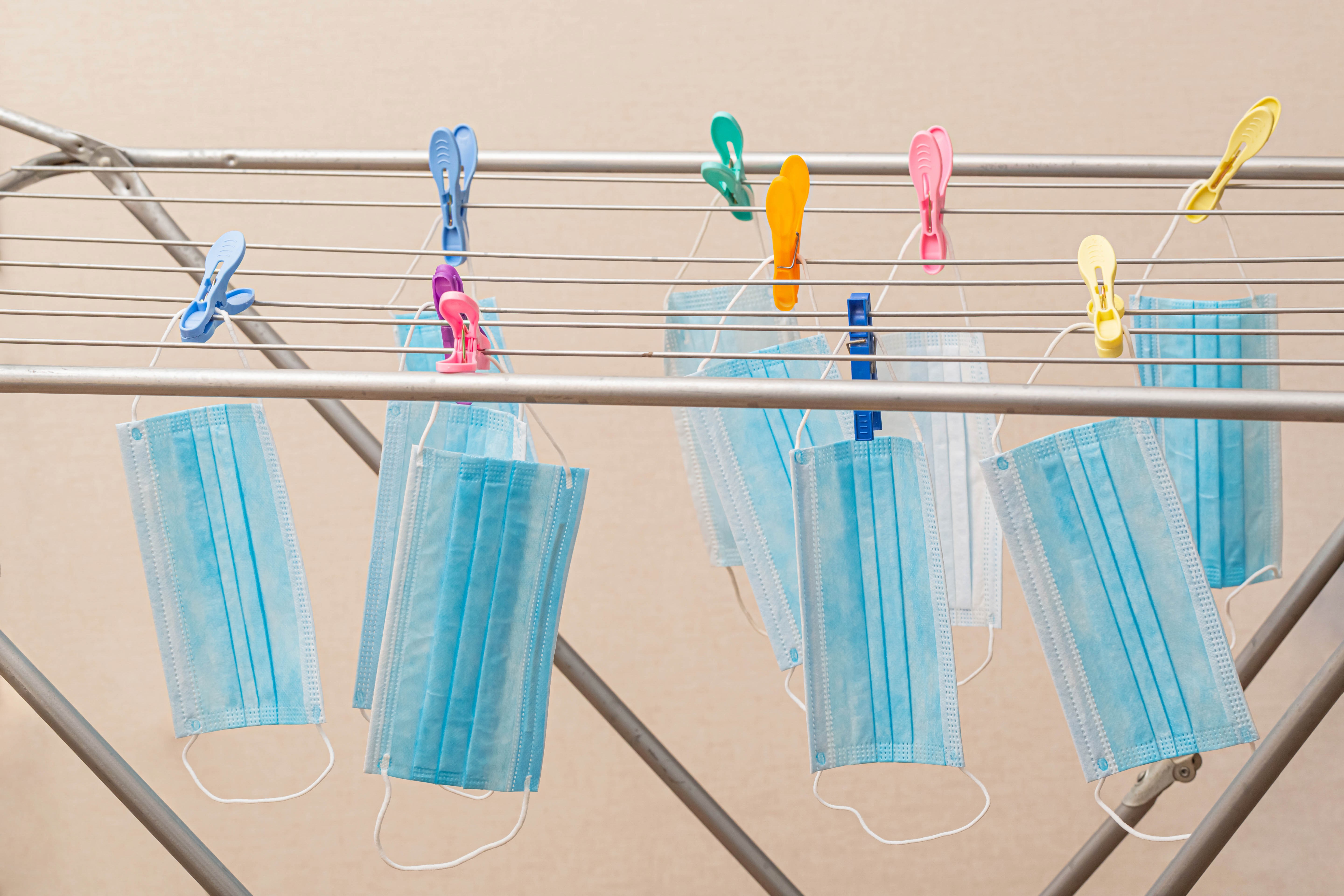 Face masks drying on a clothesline with clothespins HD Wallpaper