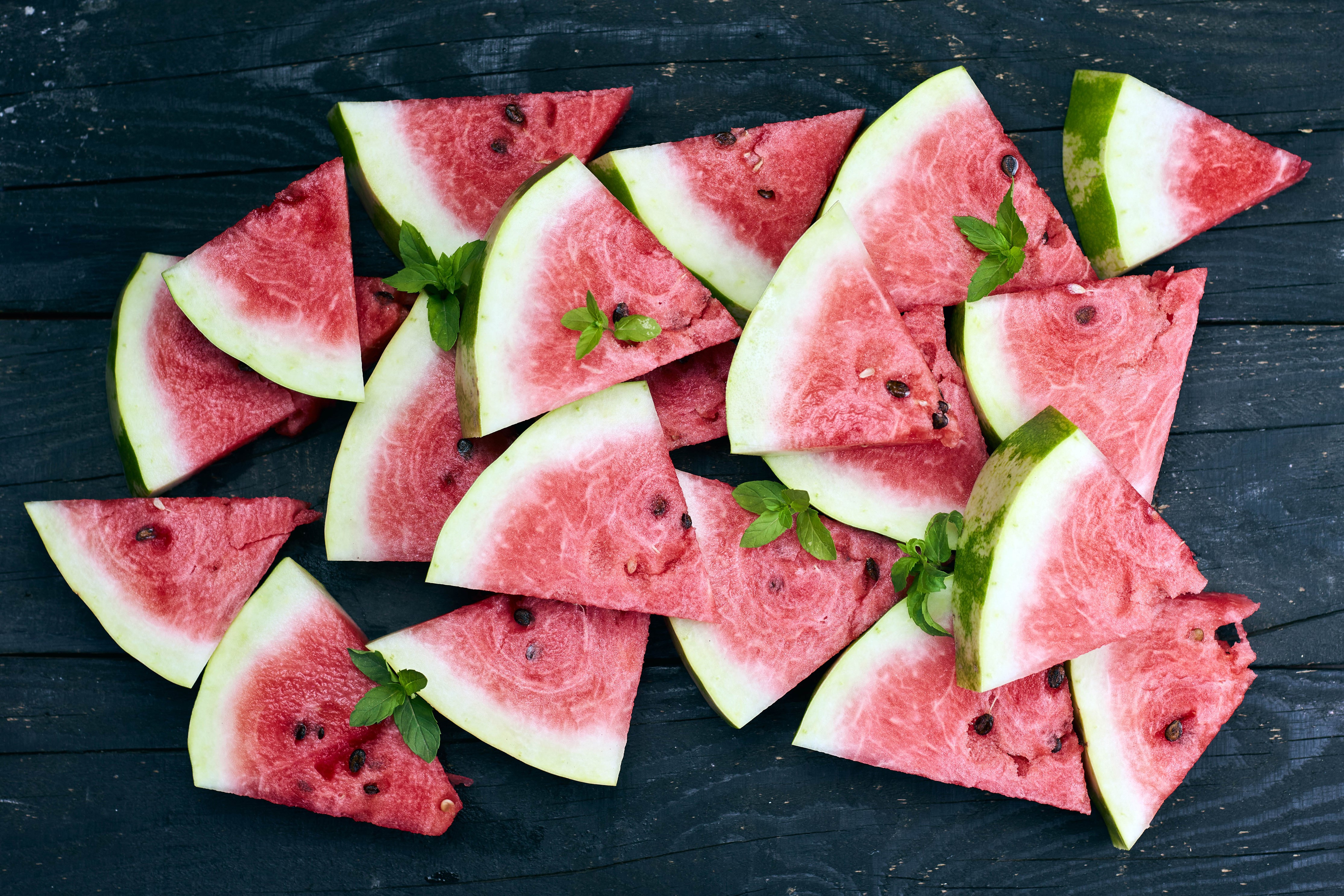 Many watermelon slices on wood planks HD Wallpaper