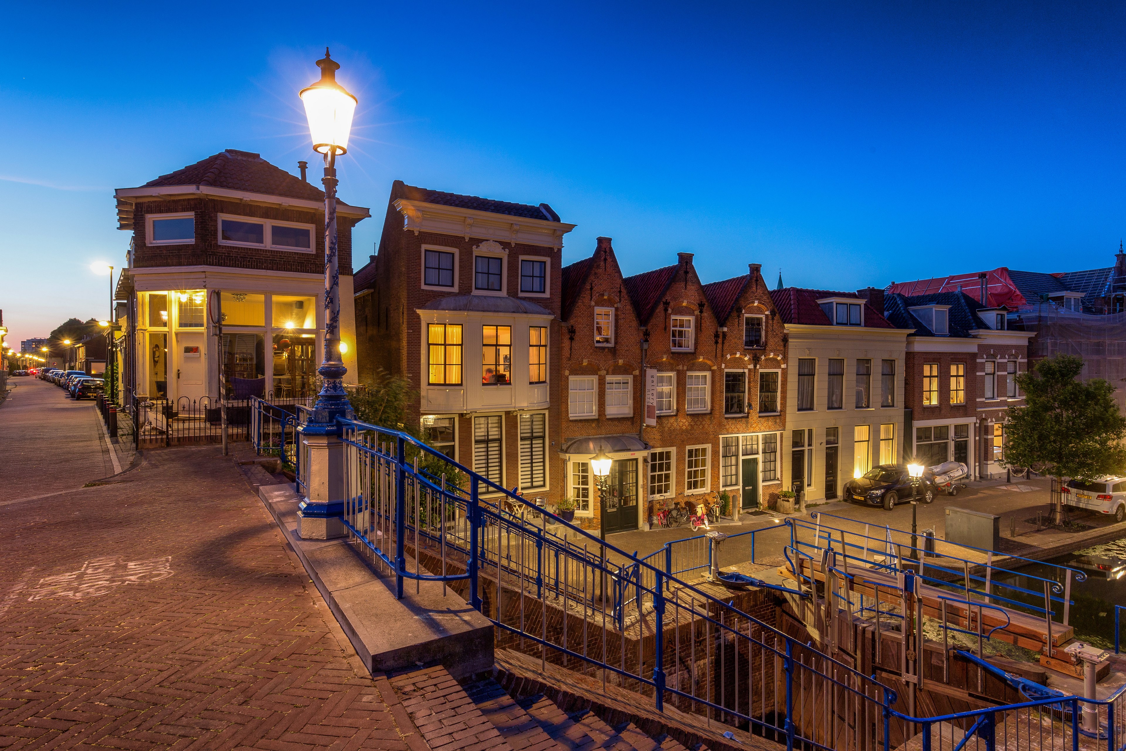 Houses and street lights in Maassluis, Netherlands at dusk HD Wallpaper