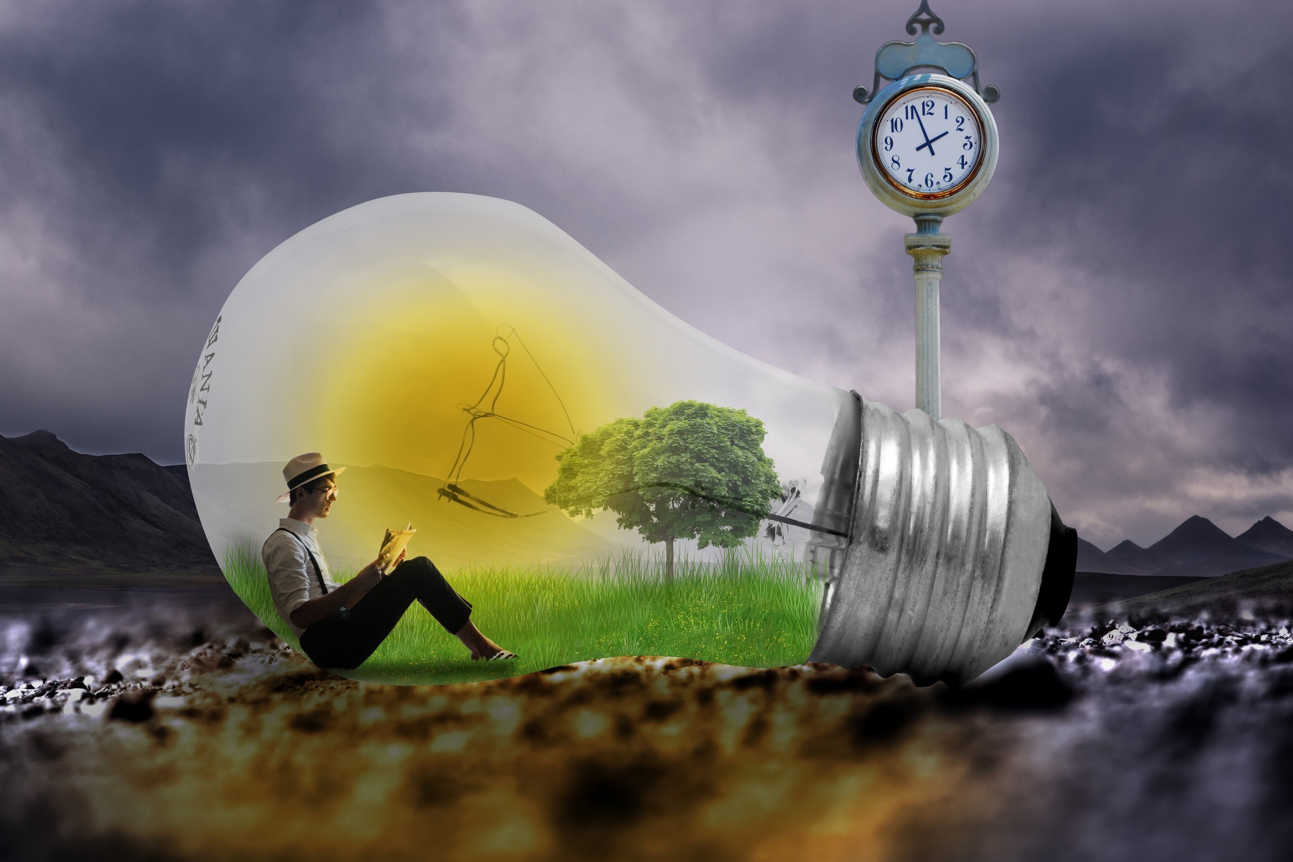 Man reading inside a light bulb with a clock HD Wallpaper