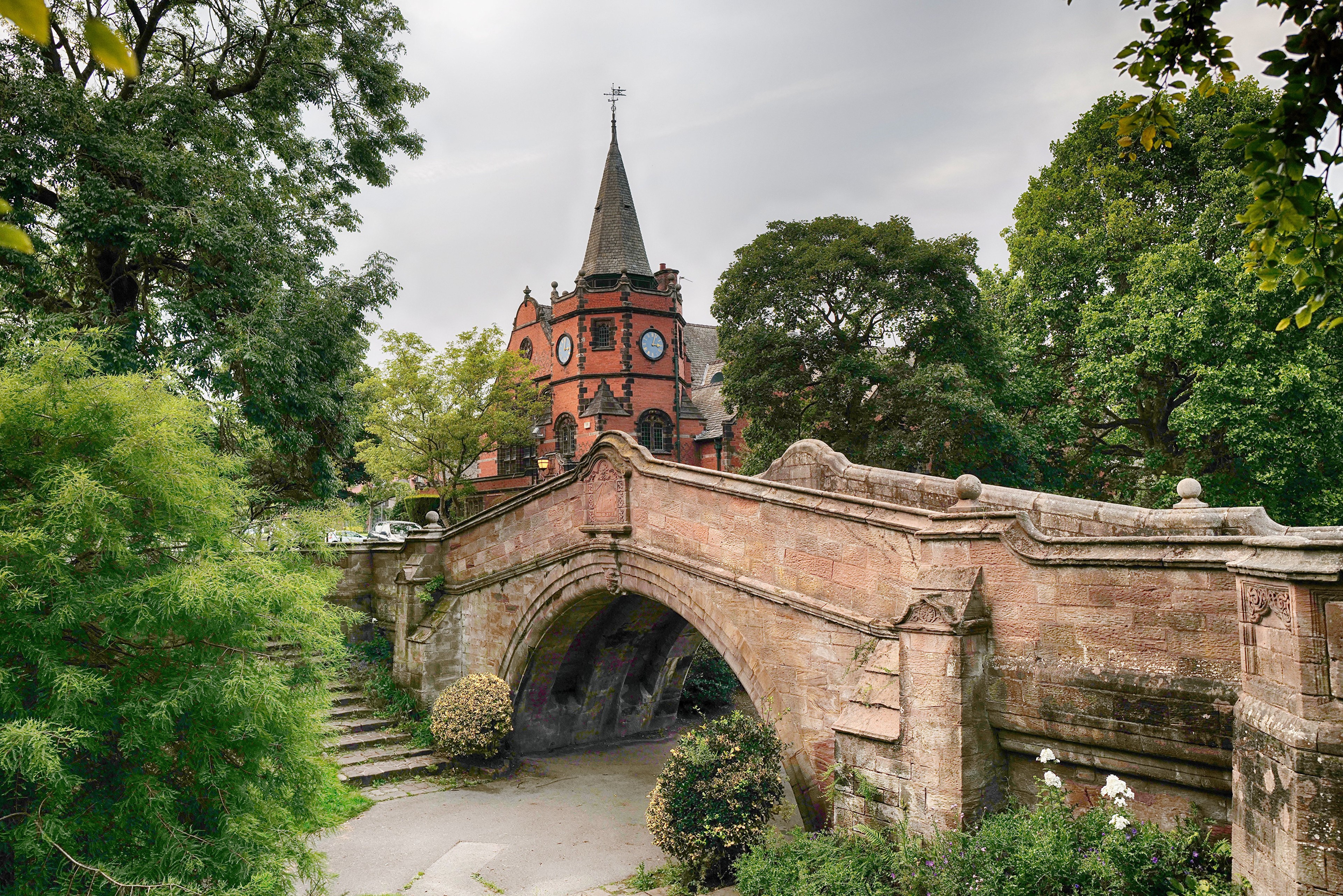 Stone bridge with church tower and trees HD Wallpaper