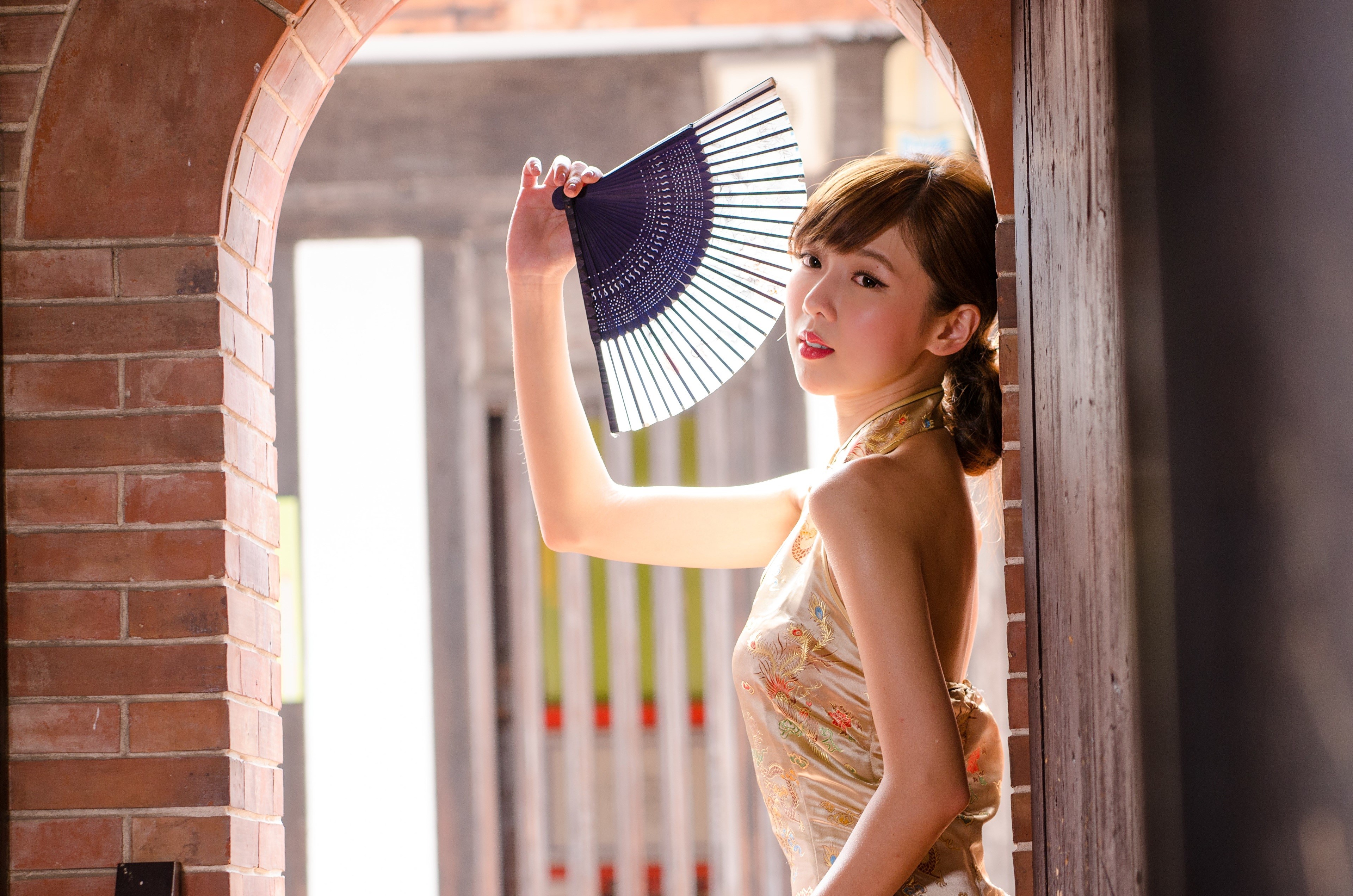 4K Asian Woman Holding Hand Fan in Archway HD Wallpaper