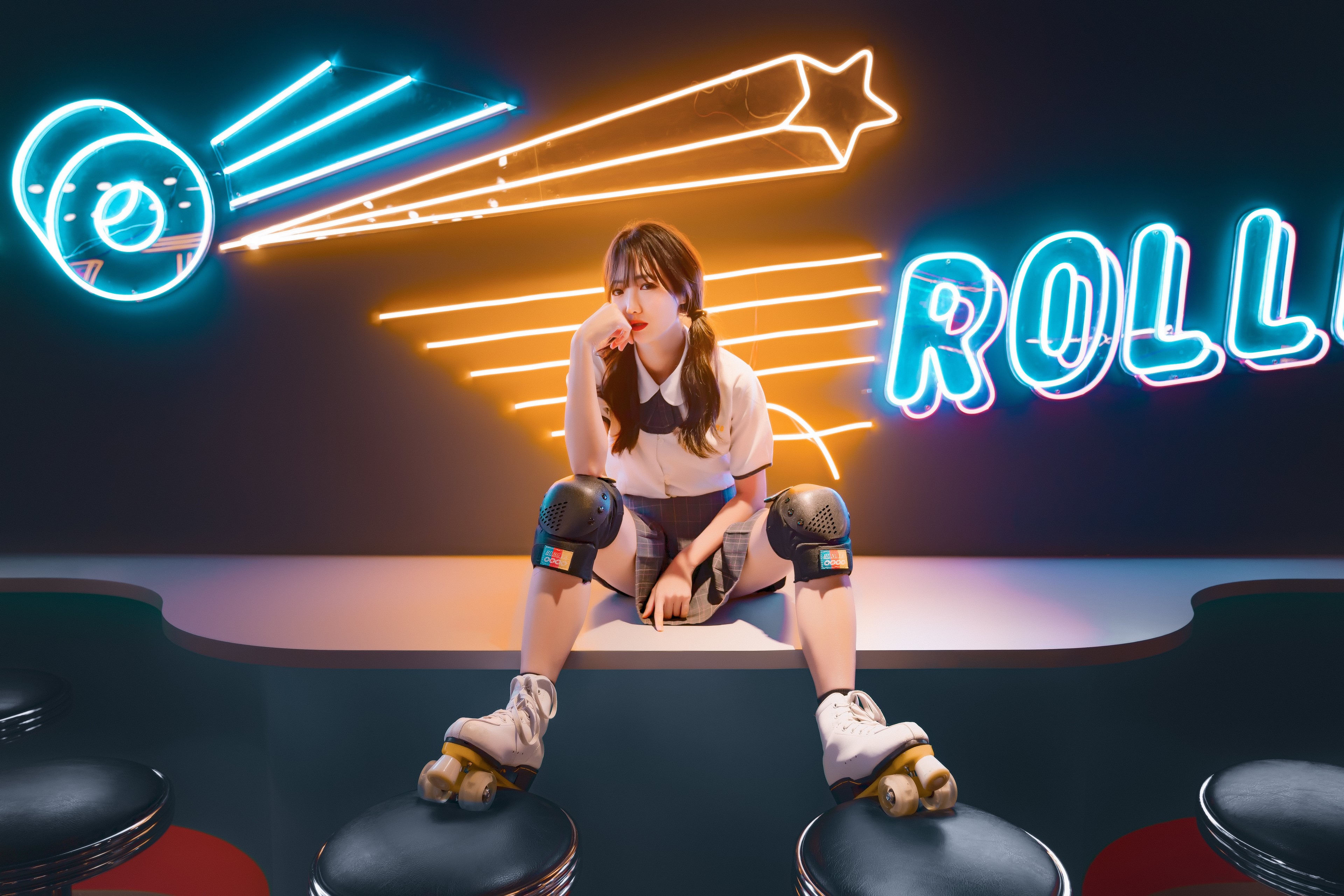 Asian girl in roller skates sitting HD Wallpaper