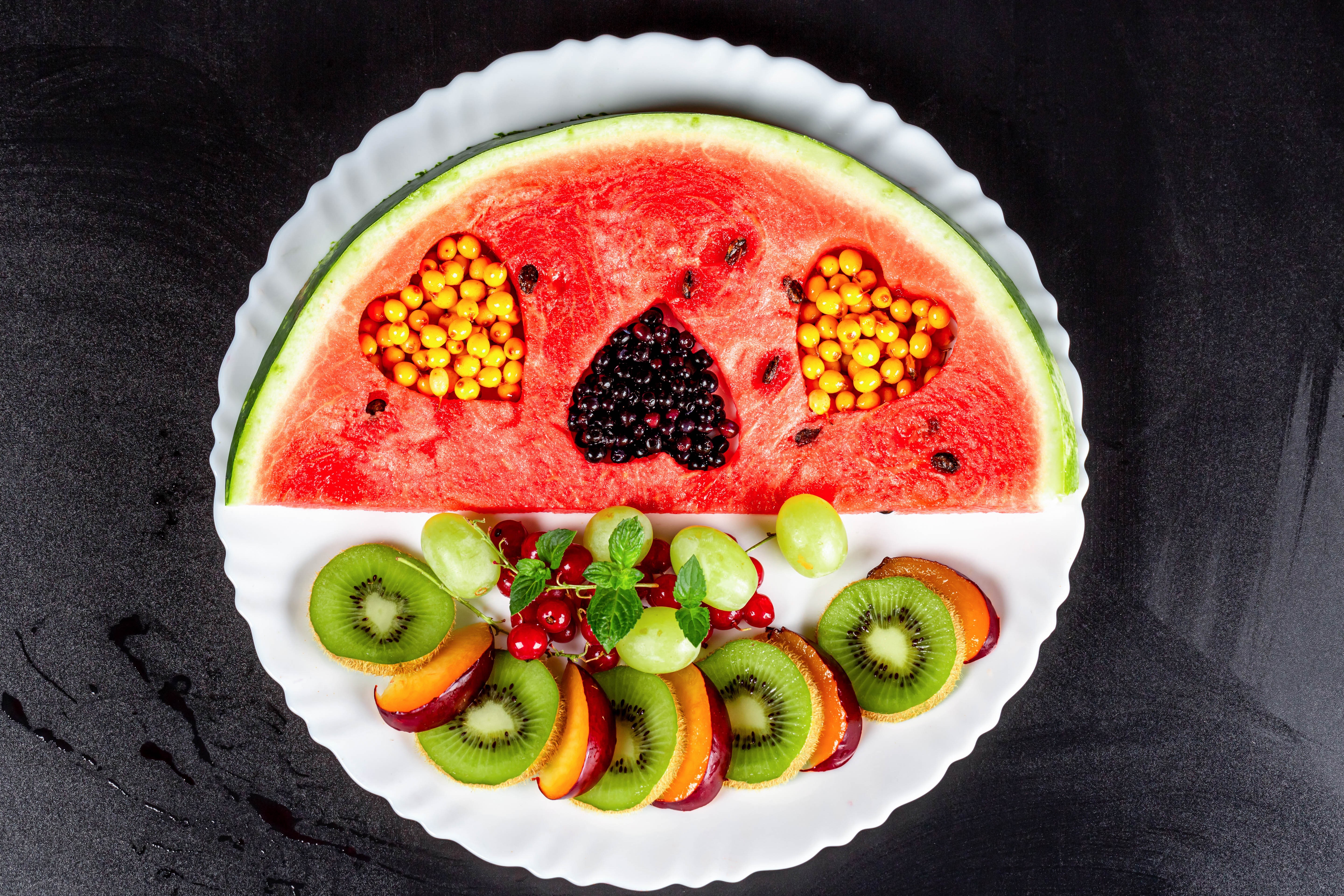 Watermelon slice with fruit hearts and sliced fruits on a plate HD Wallpaper