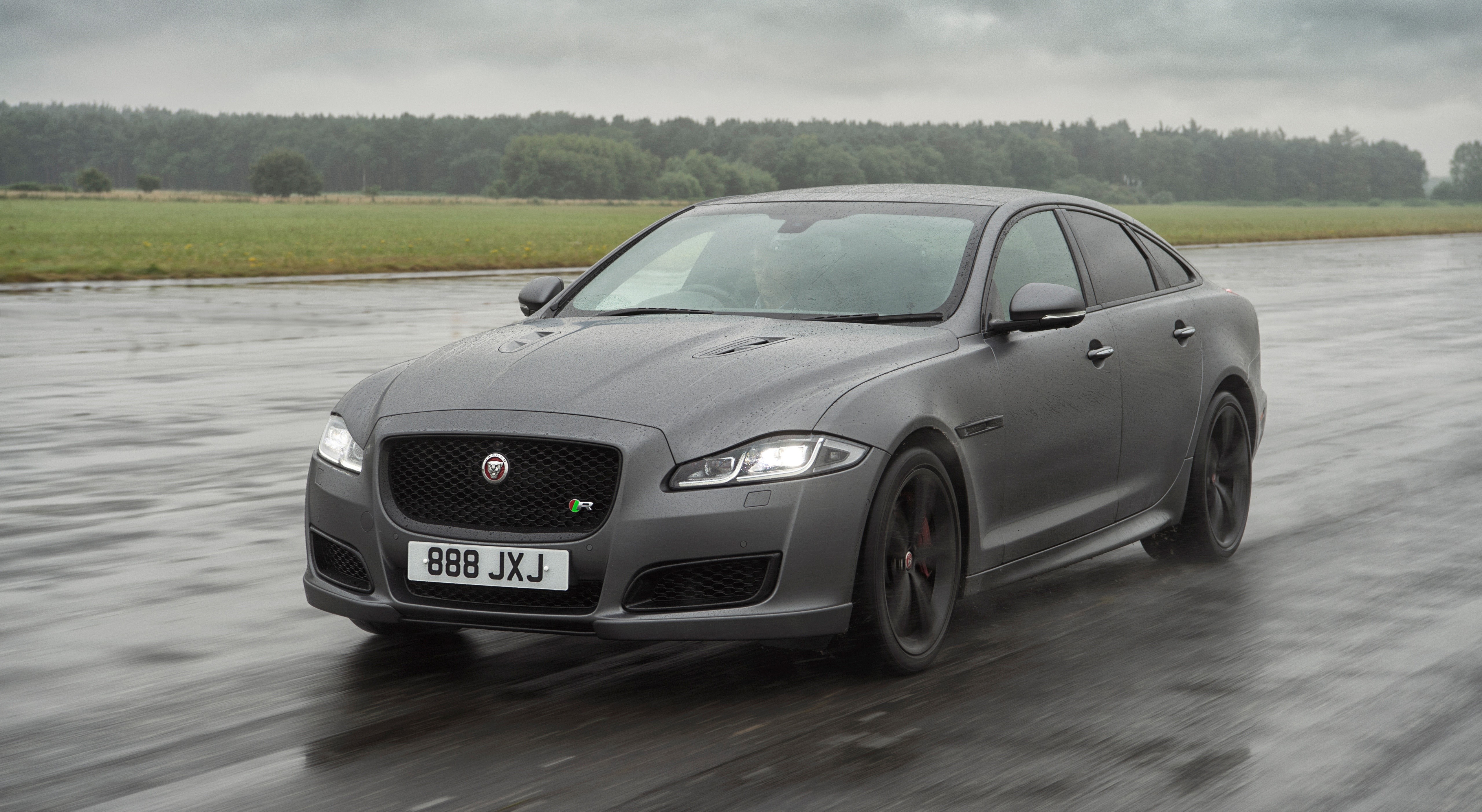 Jaguar XJR575 Sedan on a Wet Asphalt Road HD Wallpaper
