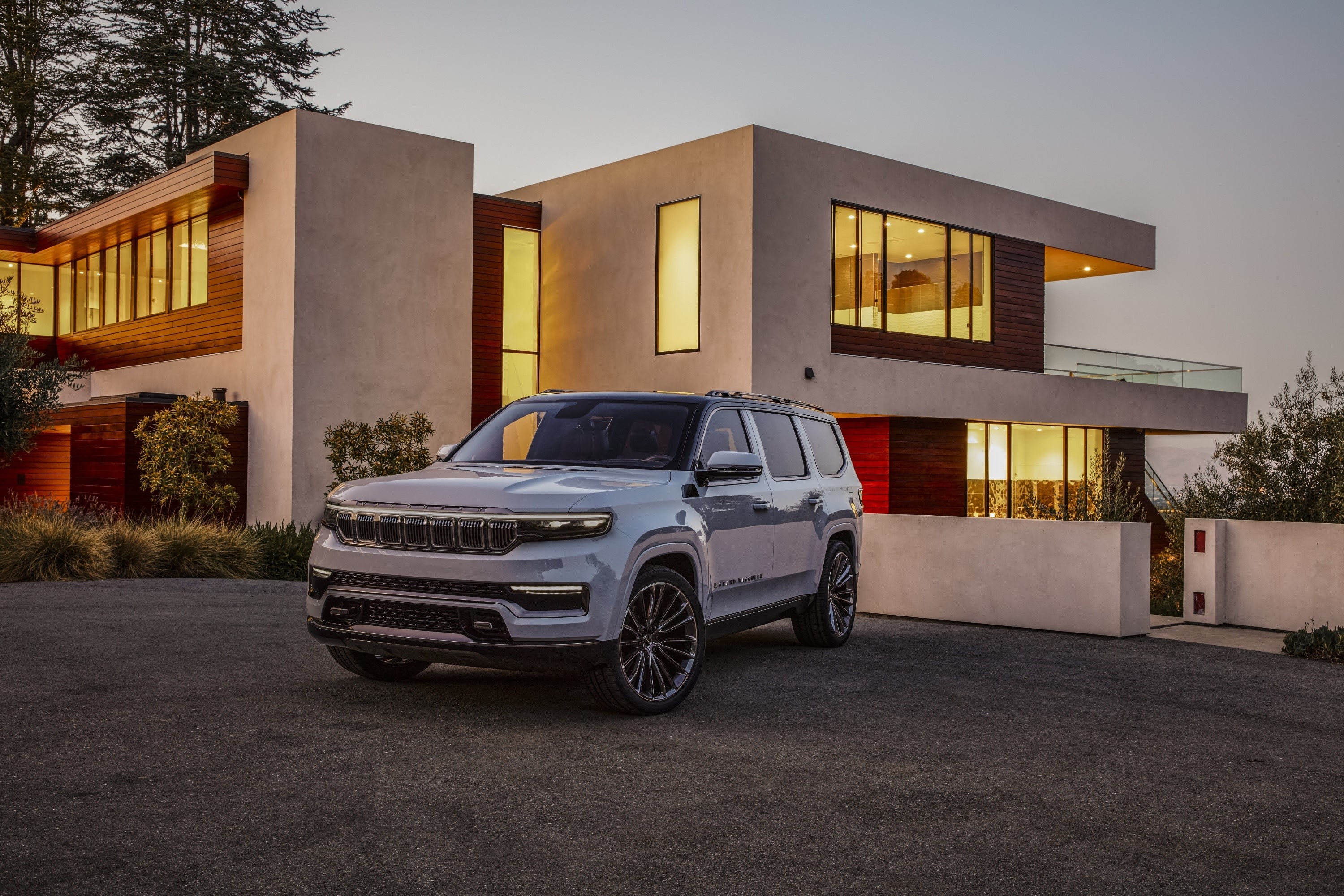 White Jeep Grand Wagoneer parked in front of modern house HD Wallpaper