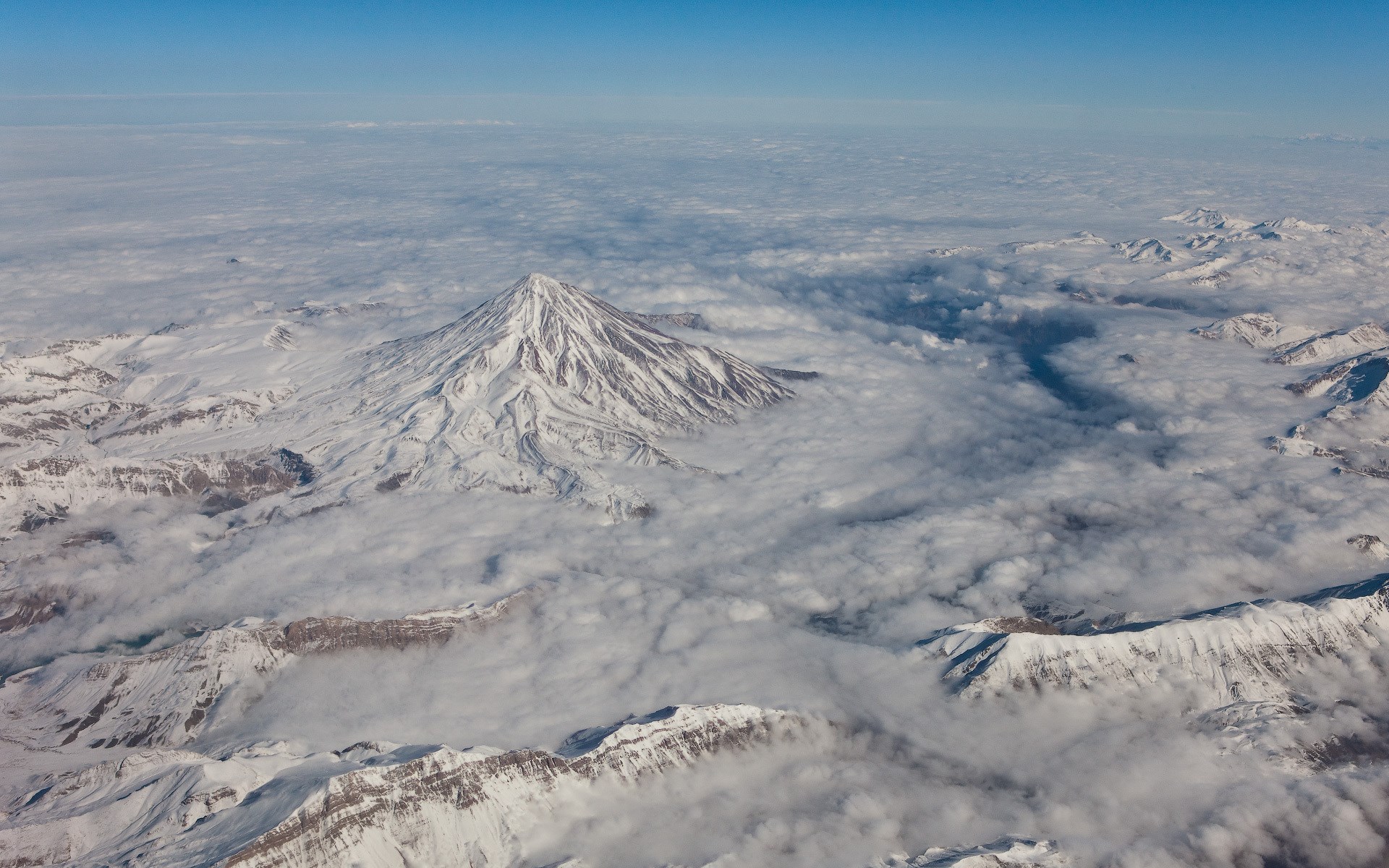 Snow-covered Mount Damavand above clouds HD Wallpaper