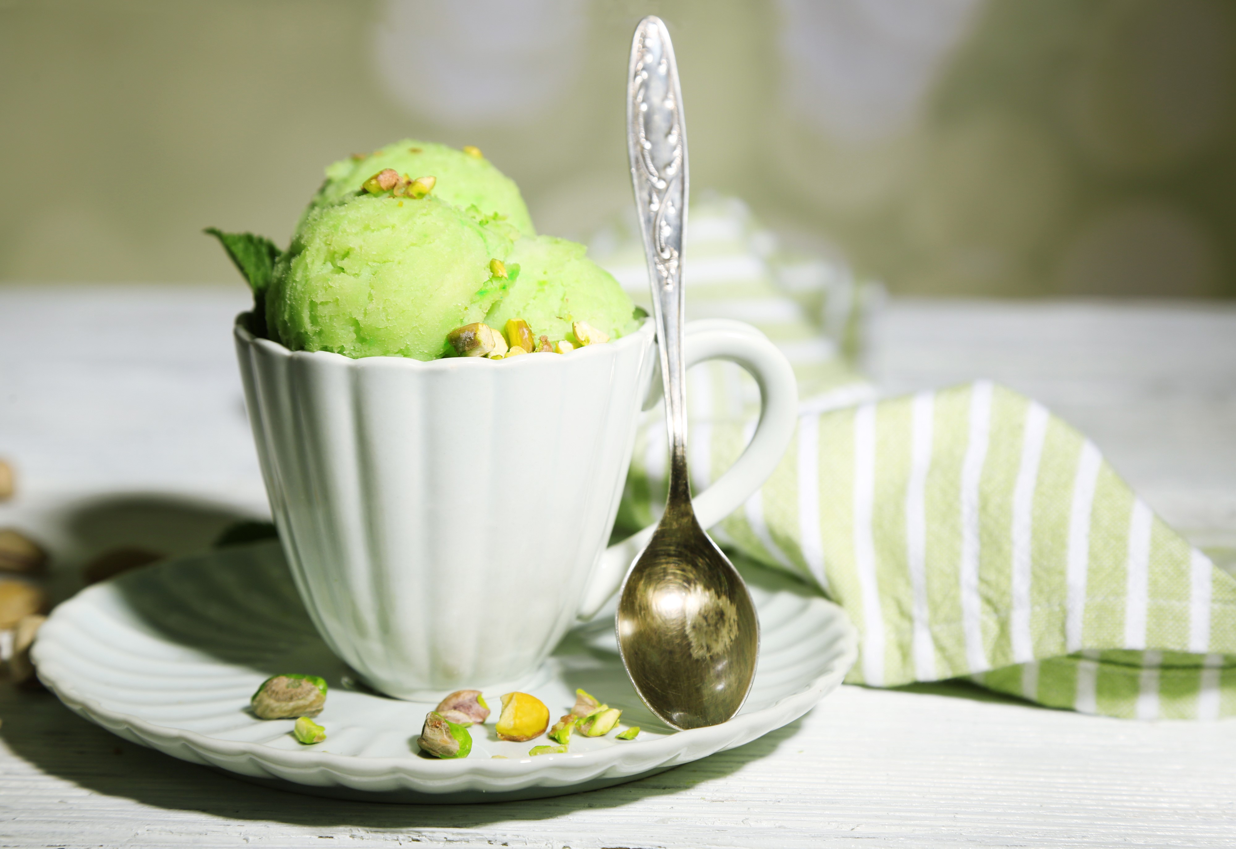 Pistachio ice cream in a cup with a spoon HD Wallpaper