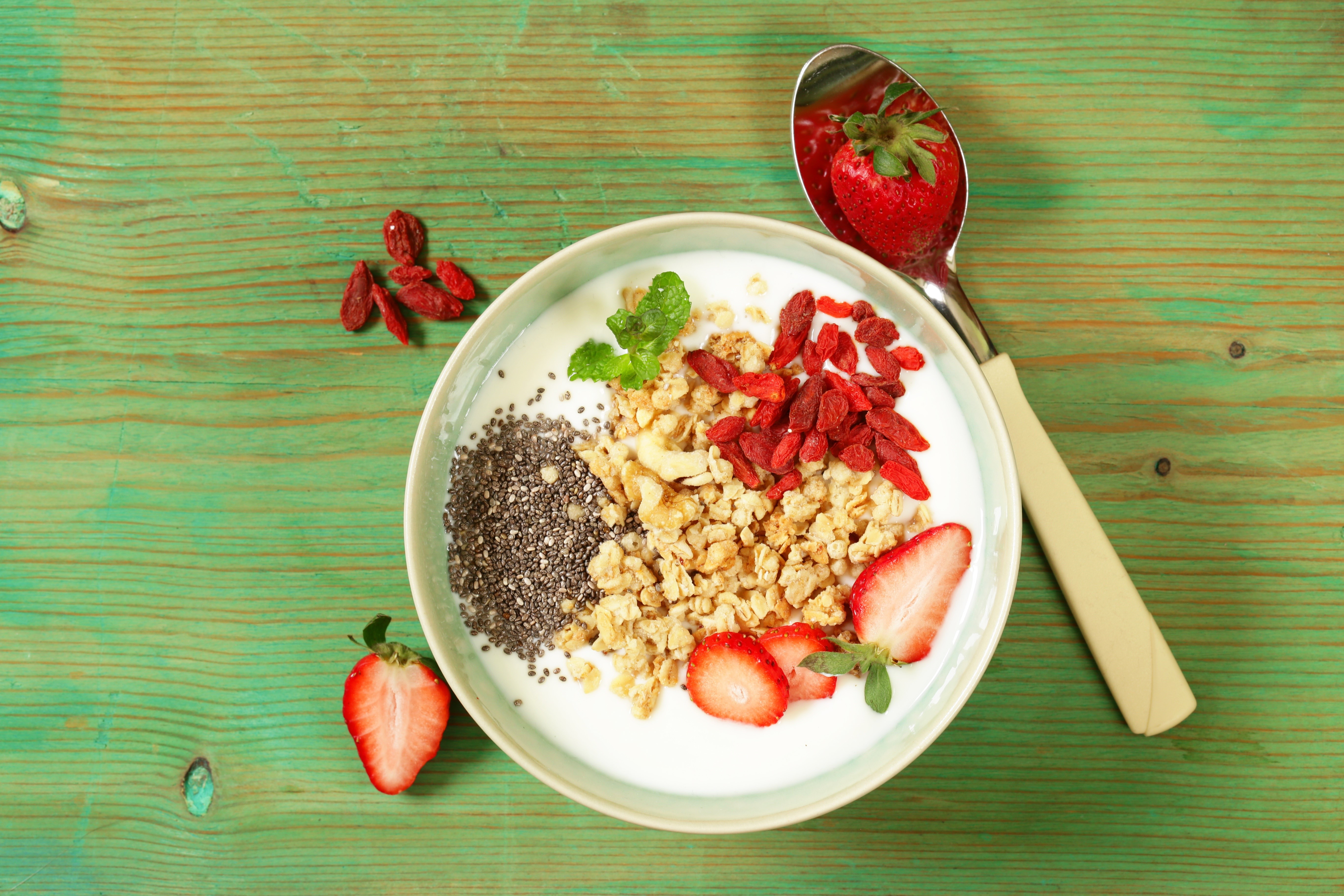 Yogurt bowl with strawberries, granola, and goji berries HD Wallpaper