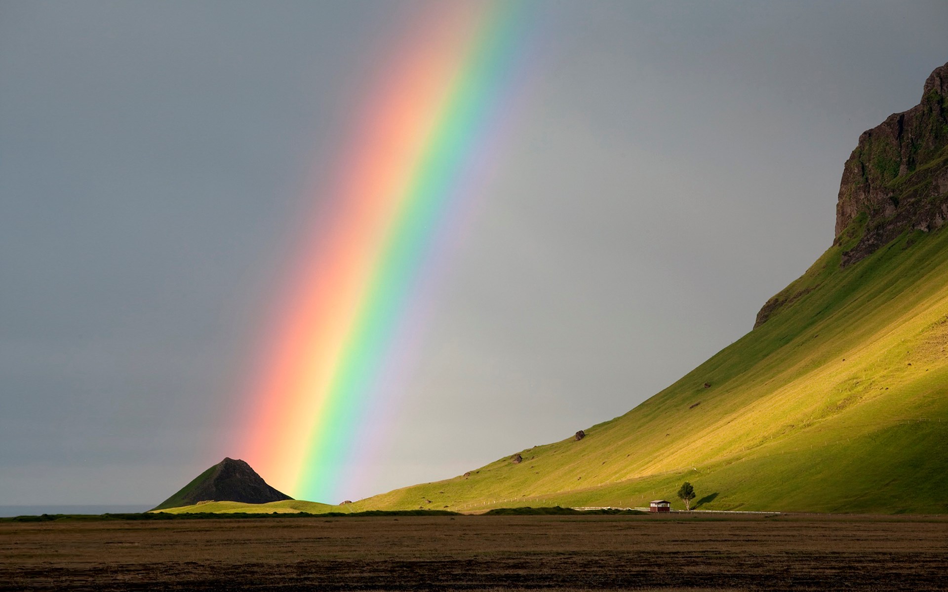 Rainbow over a green mountain landscape HD Wallpaper