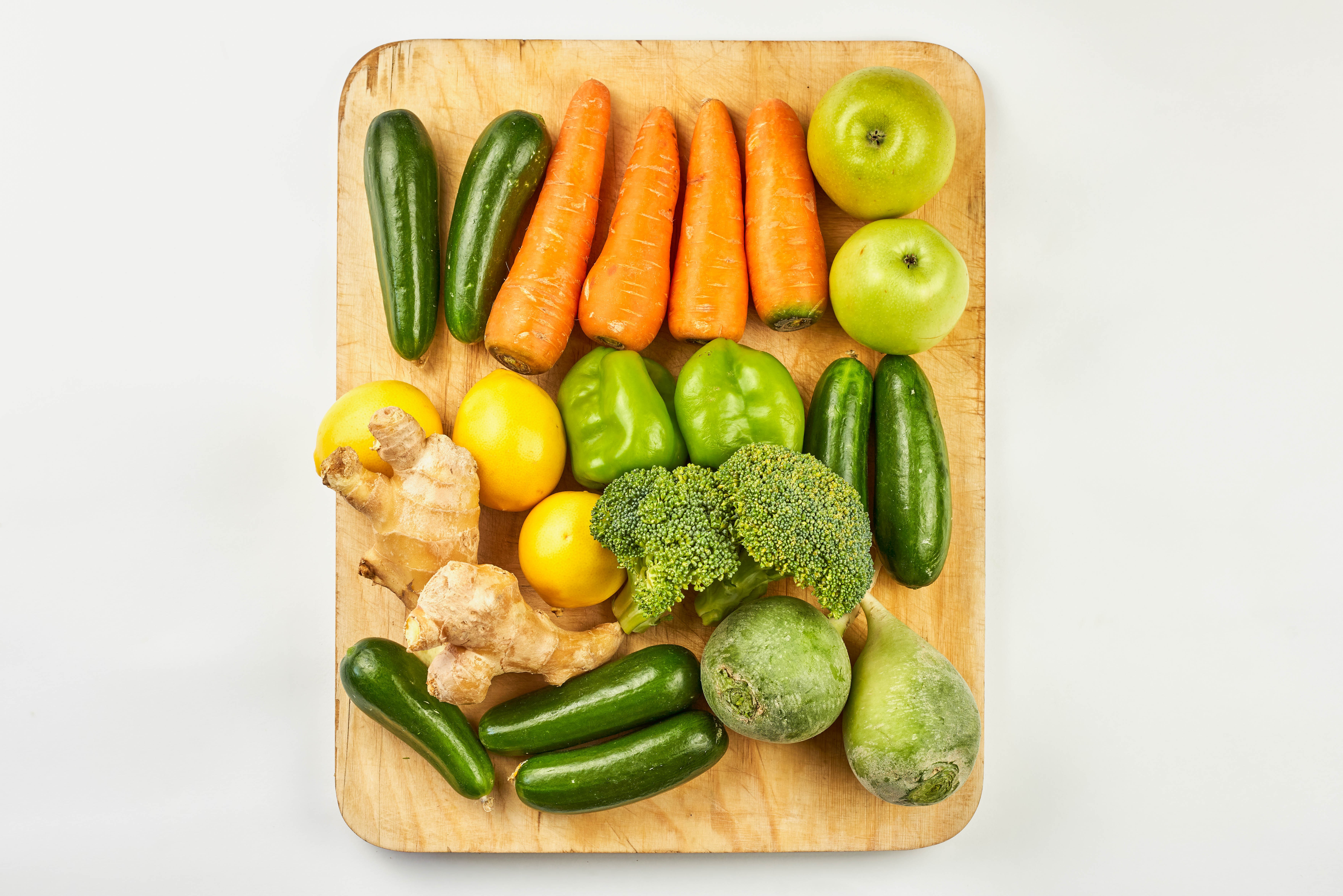 Vegetables and fruits on a cutting board HD Wallpaper