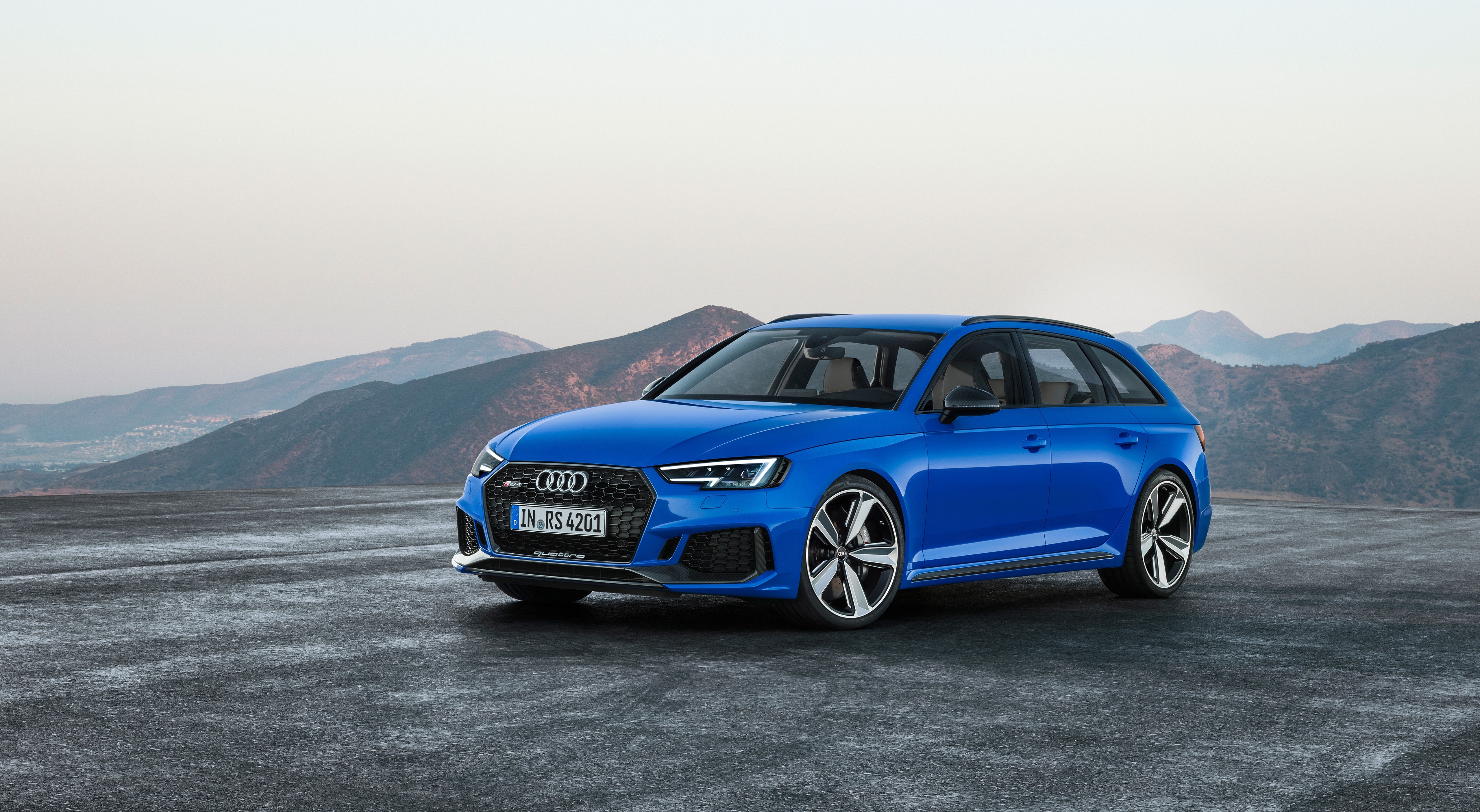 Blue Audi RS4 Avant on asphalt with mountains HD Wallpaper